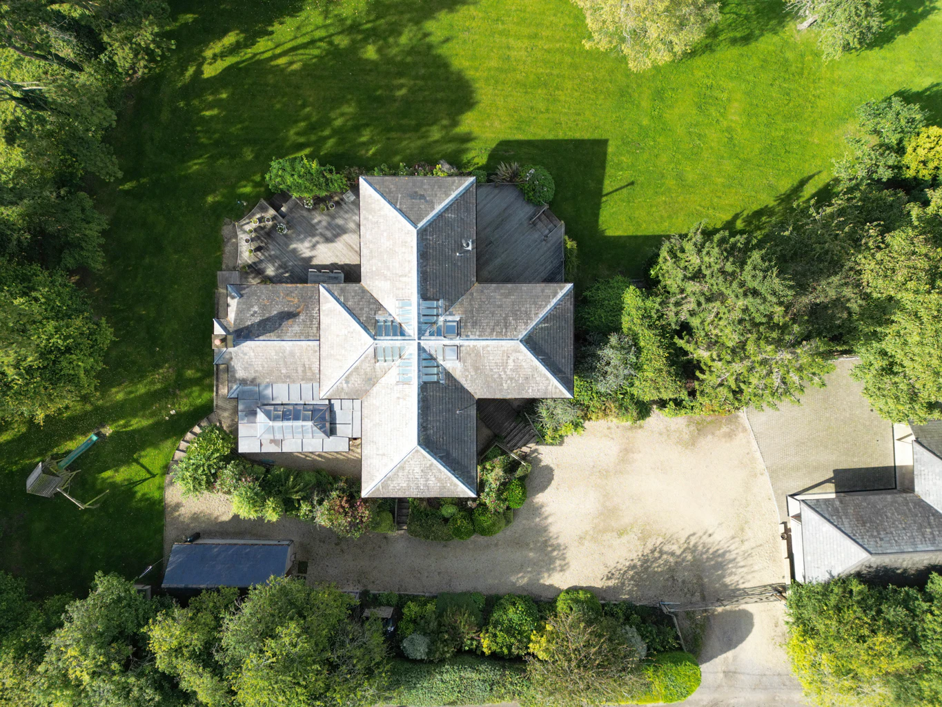An aerial view of a cross shaped oak framed house