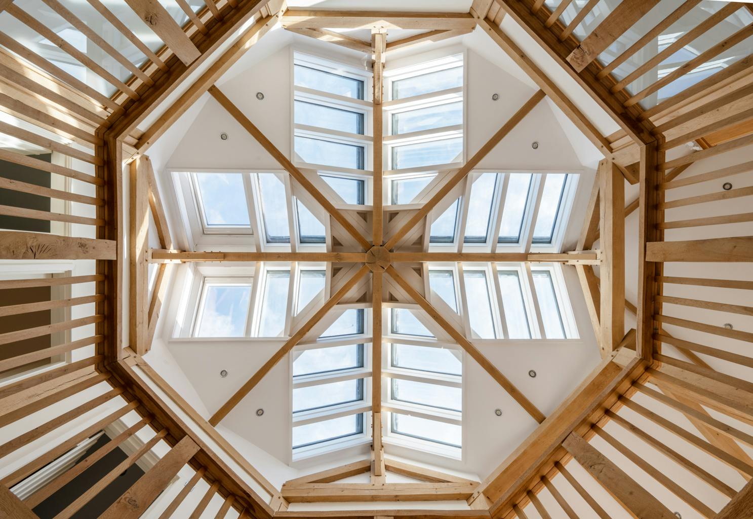 An oak frame detail showing eight sections coming together and an octagonal wooden bannister