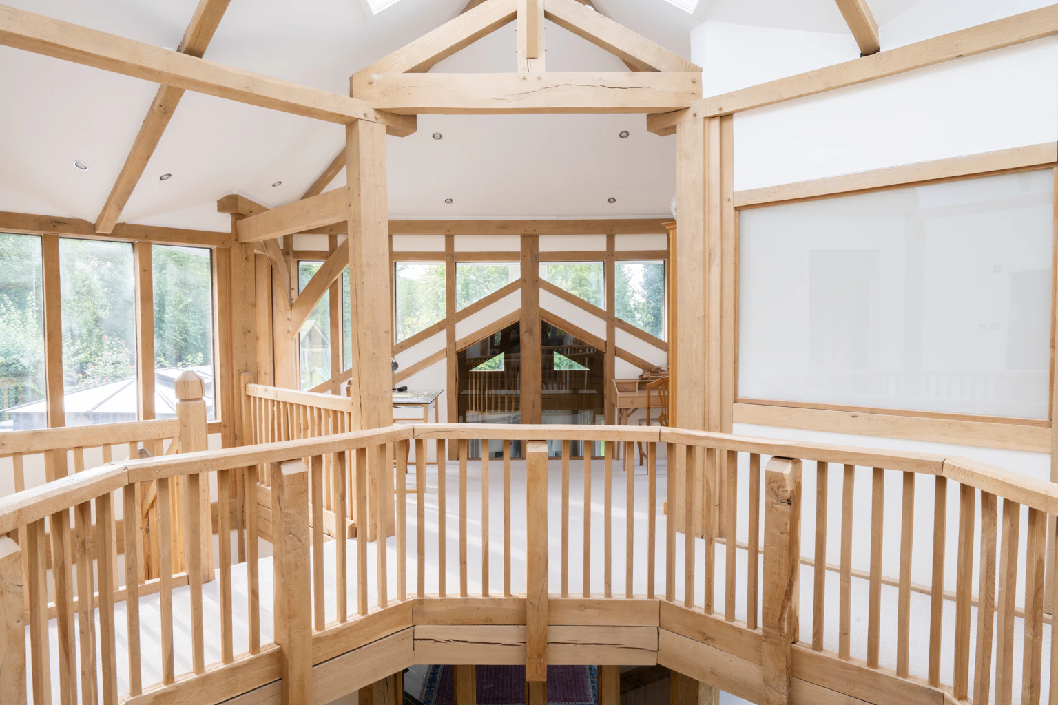 The landing area of an oak framed house showing a wooden bannister