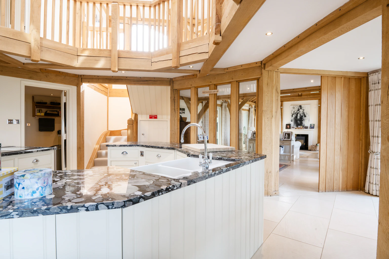 An oak frame octagonal kitchen and a wooden octagonal bannister above