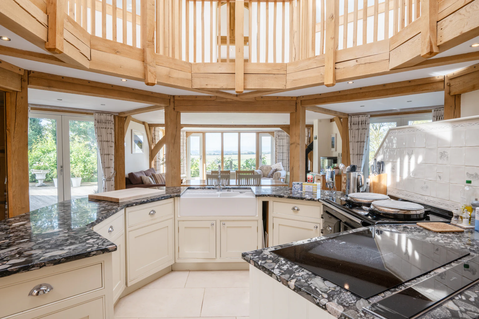 An oak frame octagonal kitchen and a wooden octagonal bannister above