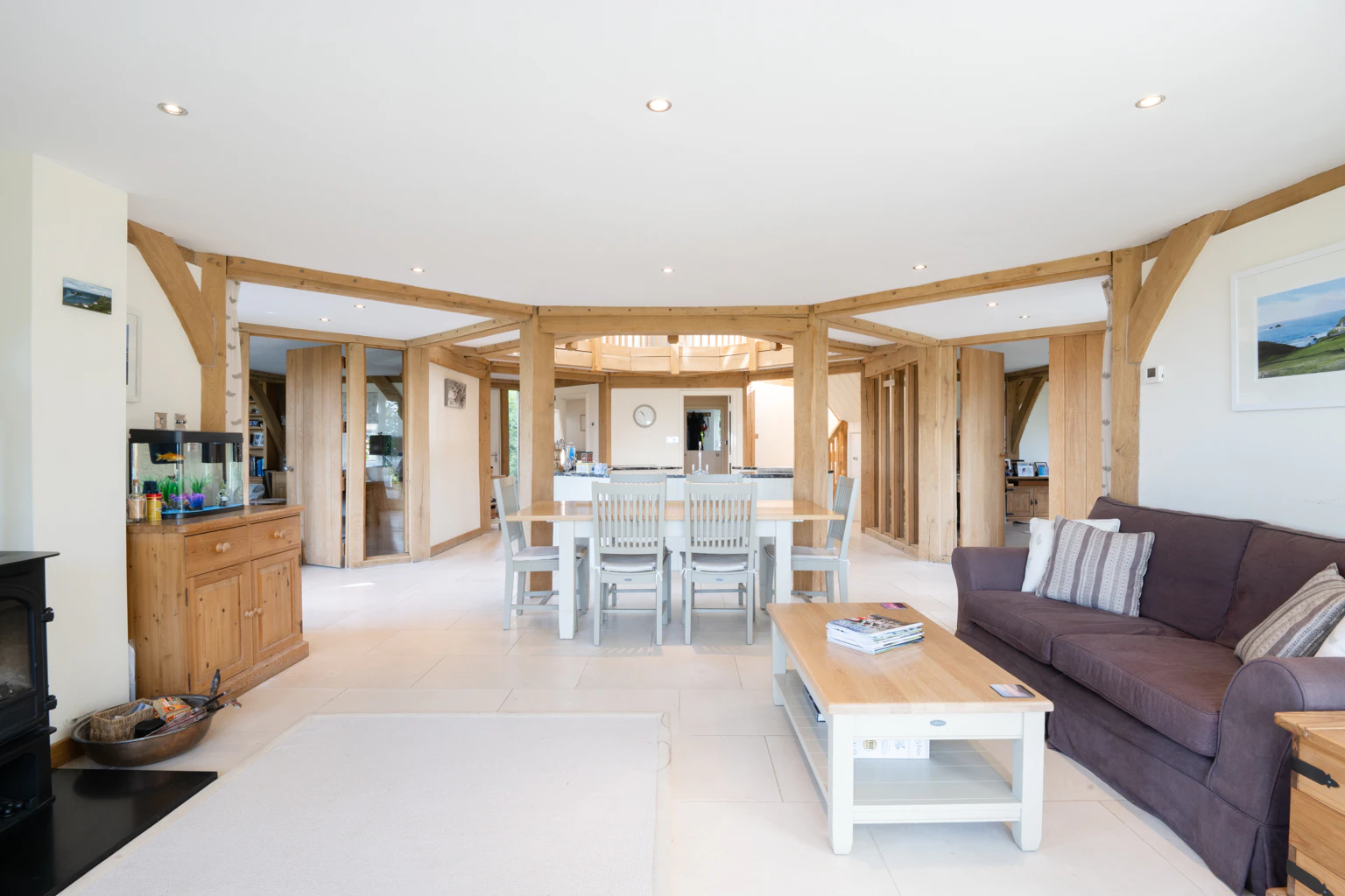 The living room of an oak framed house showing a sitting area and dining area