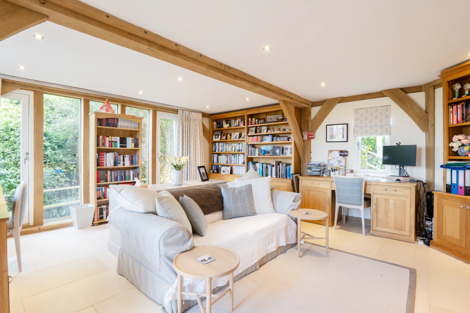An oak framed sitting area showing sofas and book cases