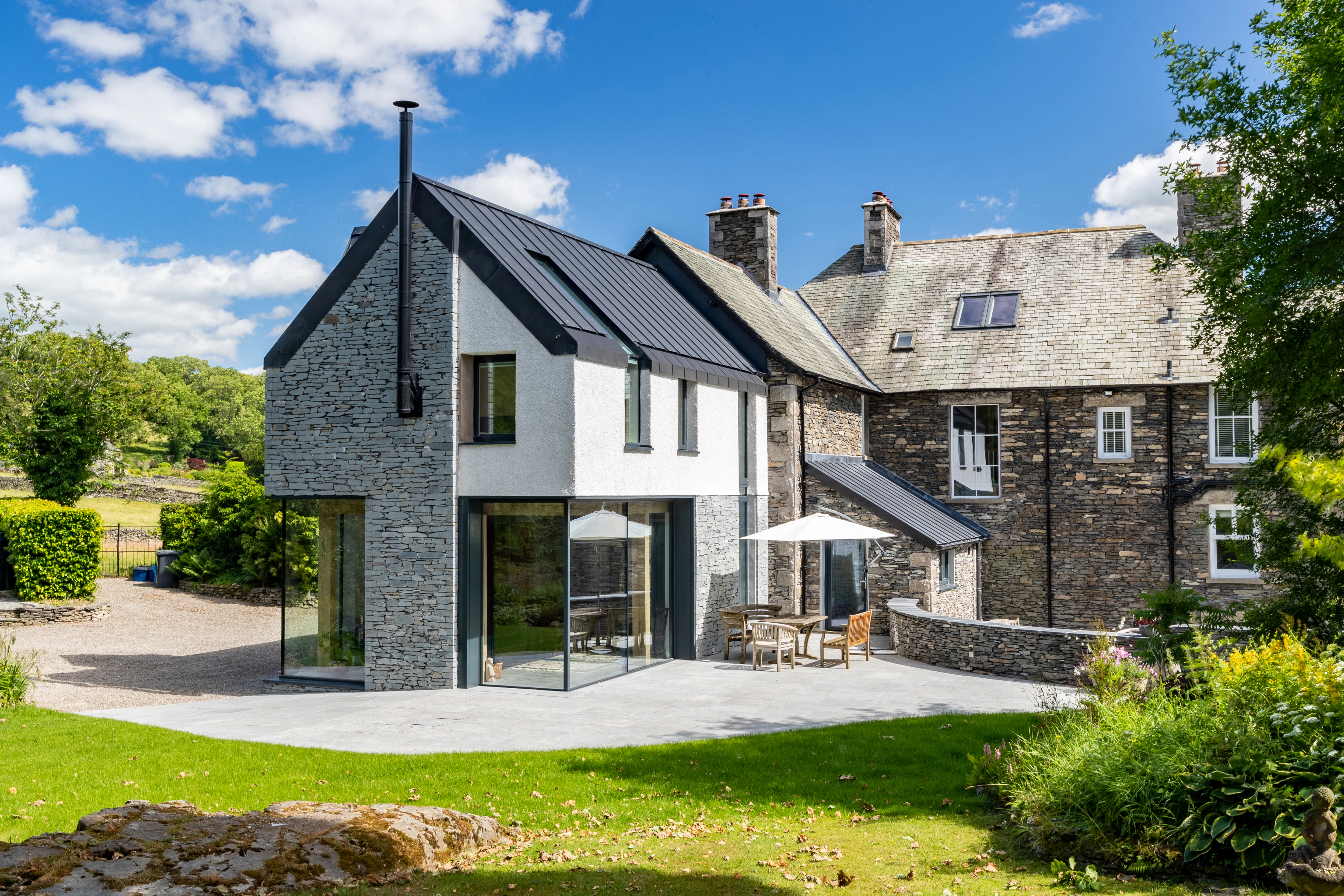 An oak frame living room extension to an Edwardian vicarage with direct access to a terrace and garden