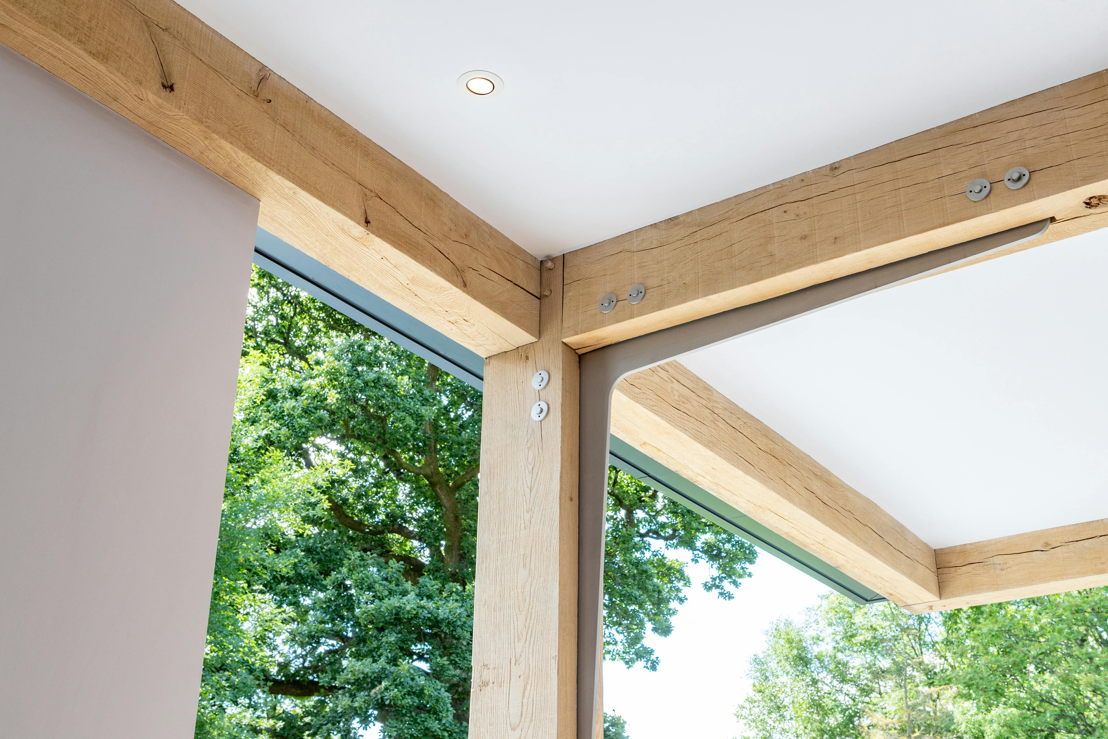 An oak frame with steel flitch plate joints in the middle and steel bolts