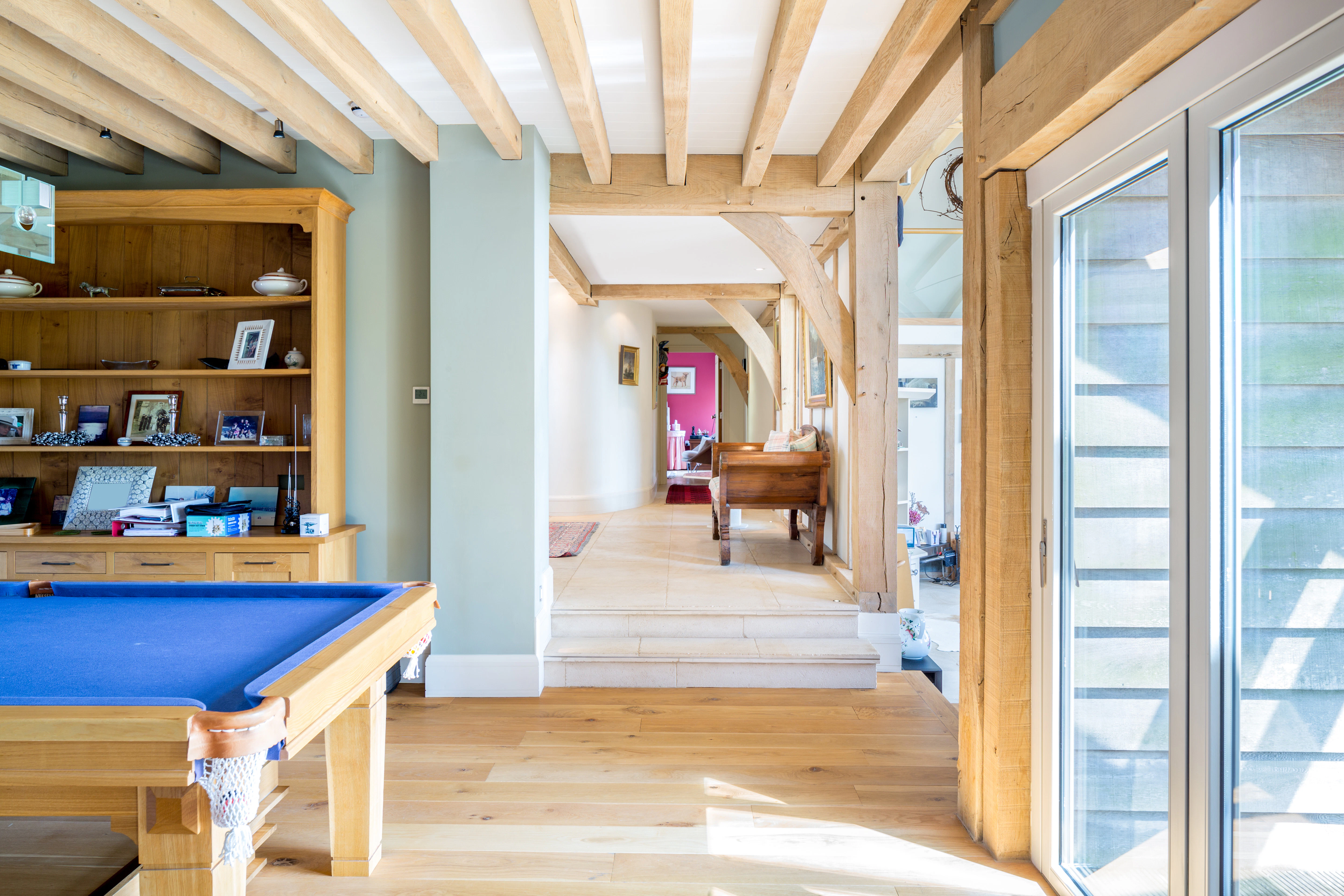 Interior view of an oak-framed hallway that connects three rooms