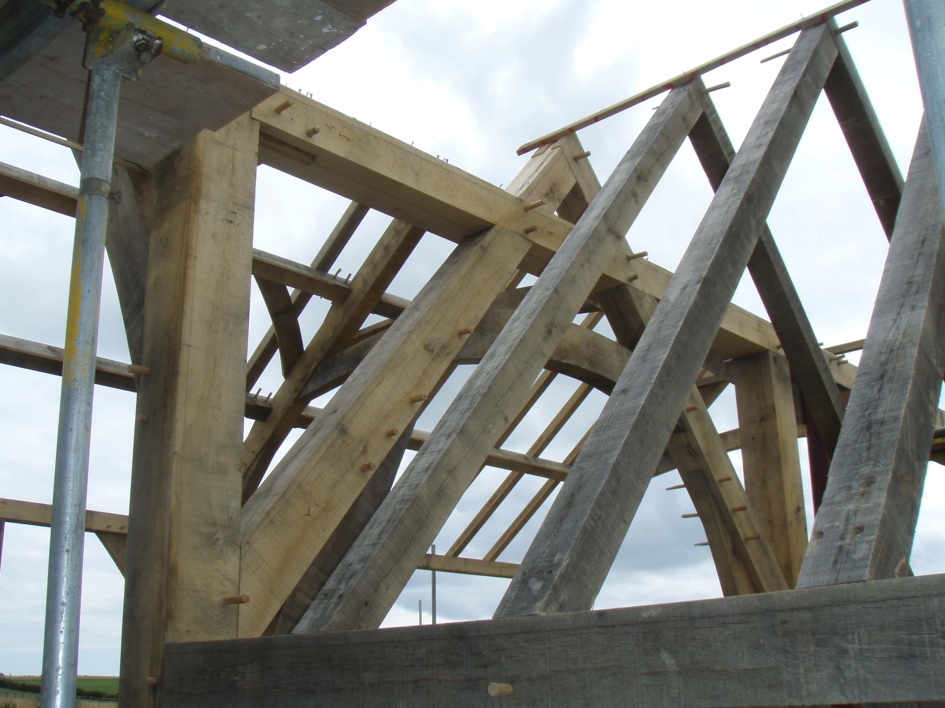 Image of timber frame trusses assembled on-site, forming a vaulted ceiling in the family home