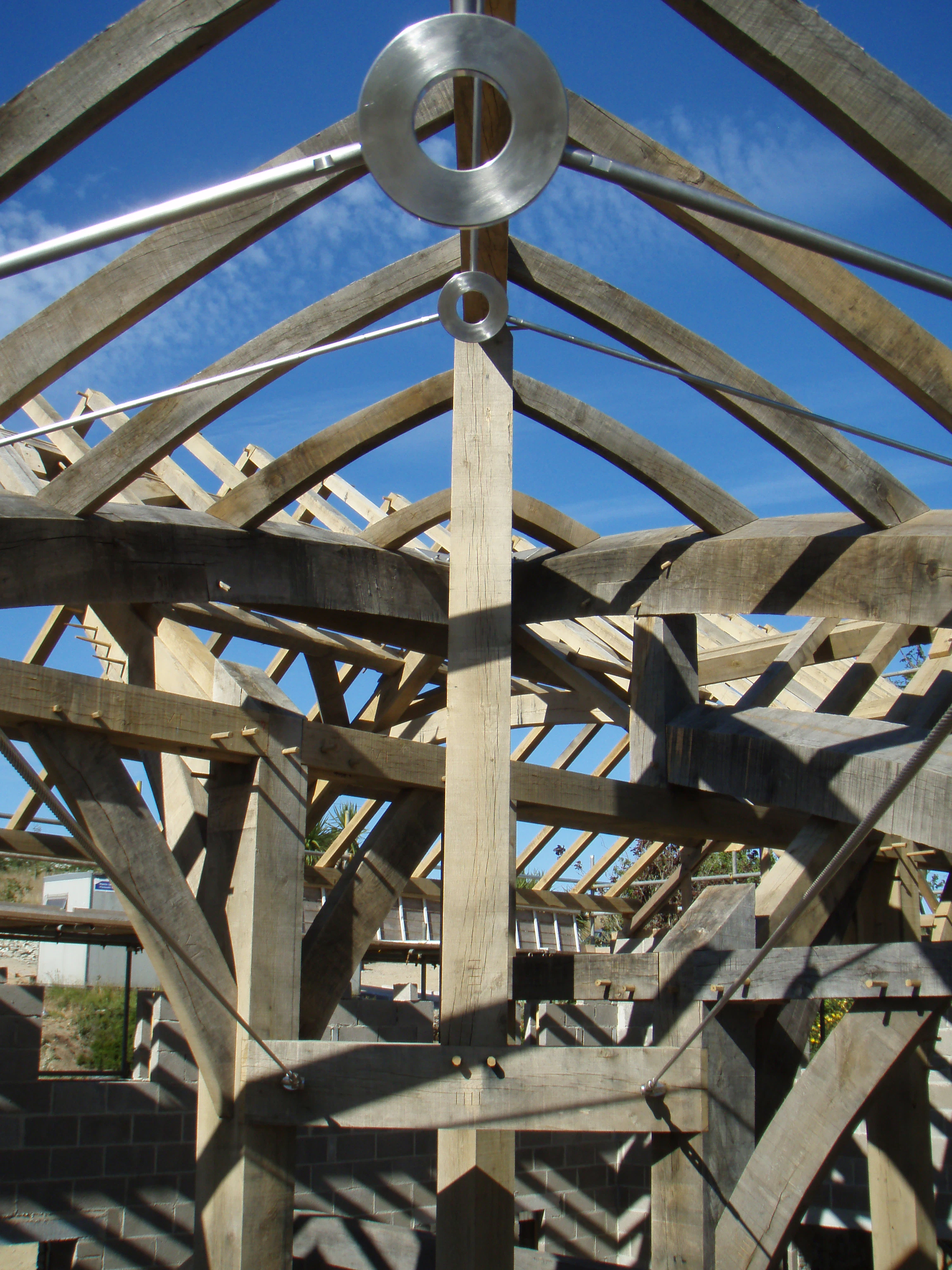 Close-up detail of steel tie rods within the boat roof structure of the family room on-site