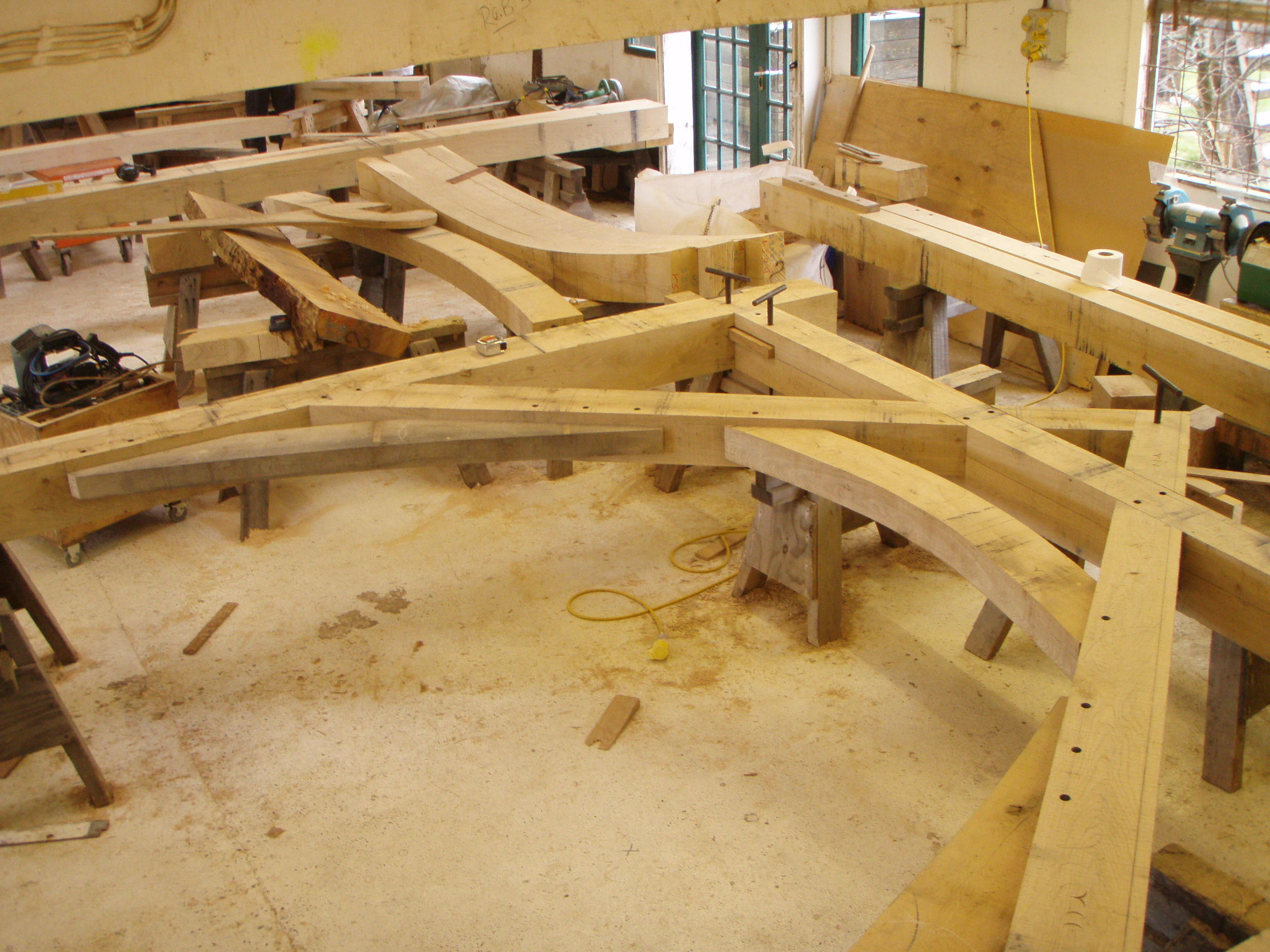 Pre-assembling a hybrid oak truss that combines sling brace and arch brace trusses in the workshop