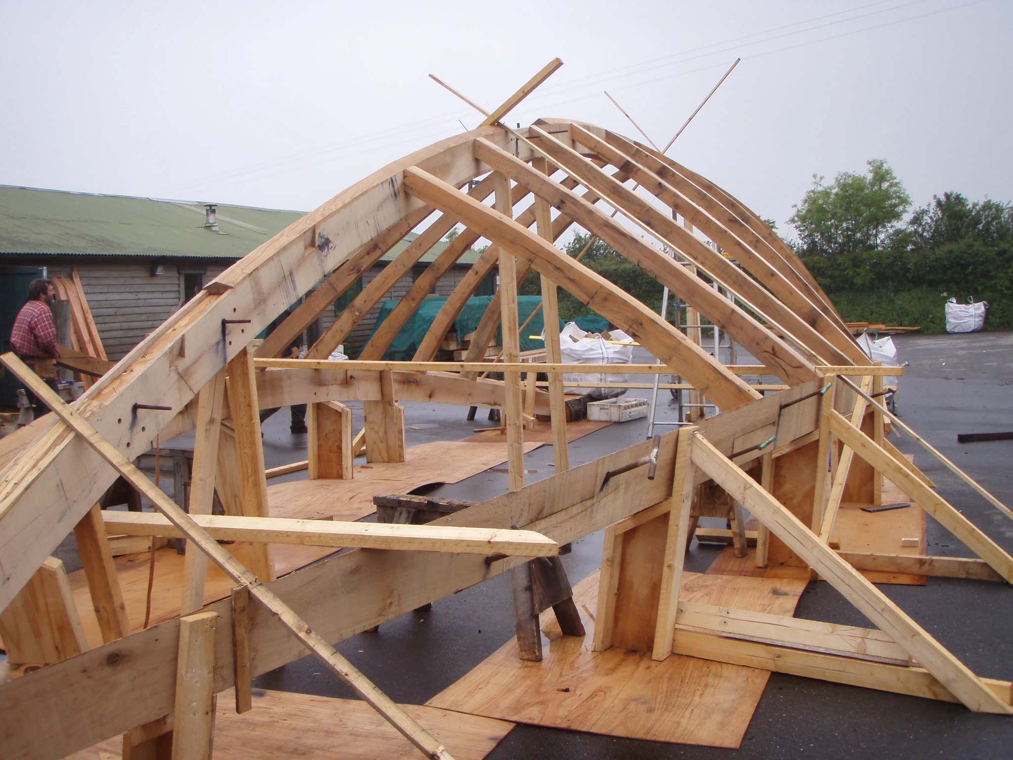 Boat roof structure with curved oak beams, assembled in the timber framing yard