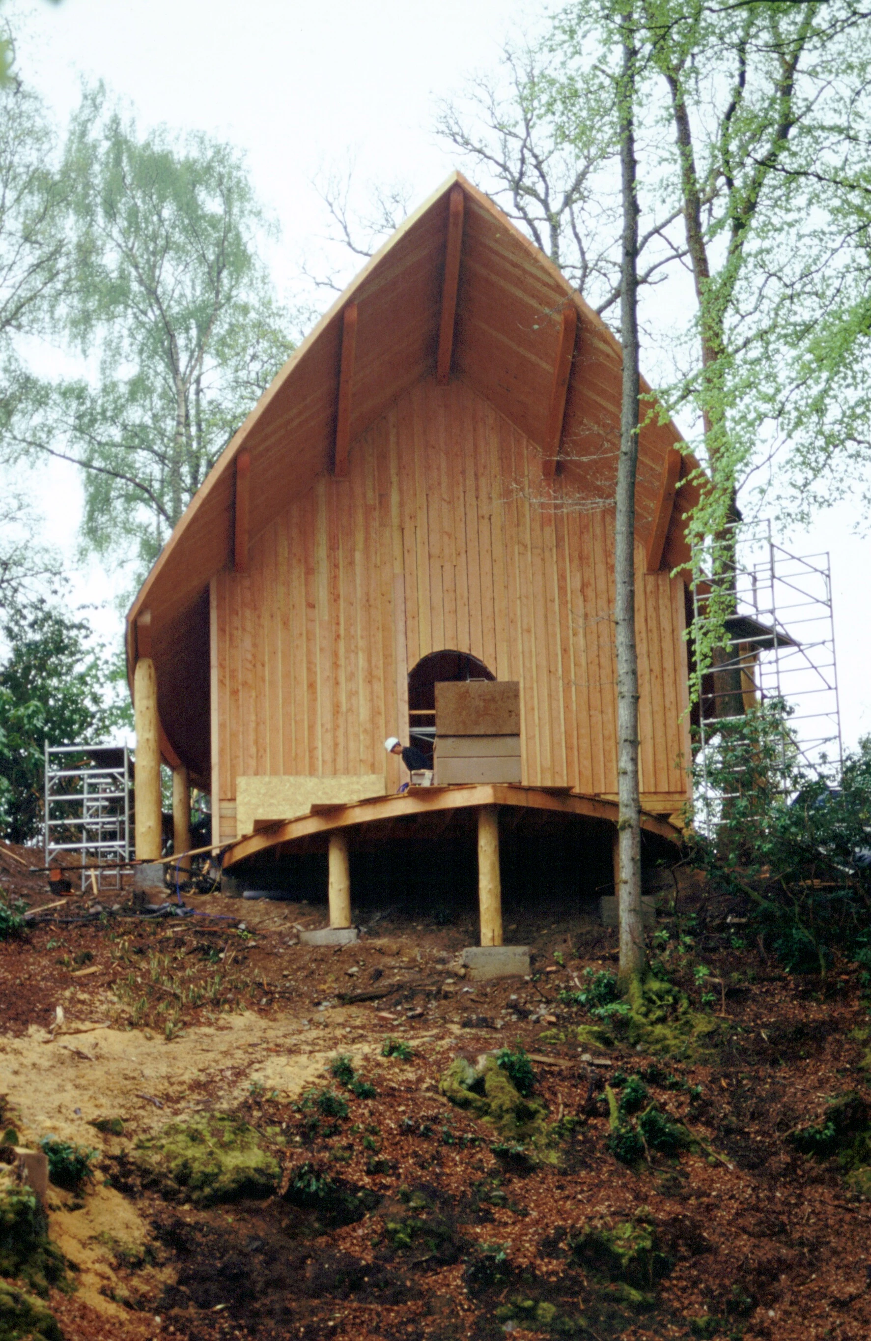 A wooden pavilion with an angled roof during construction