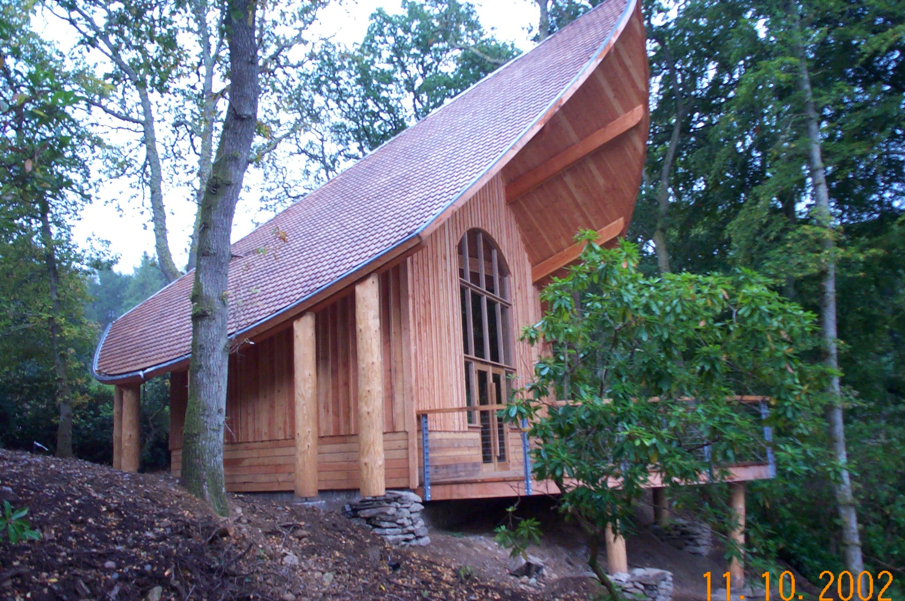 A wooden pavilion with an angled roof during construction