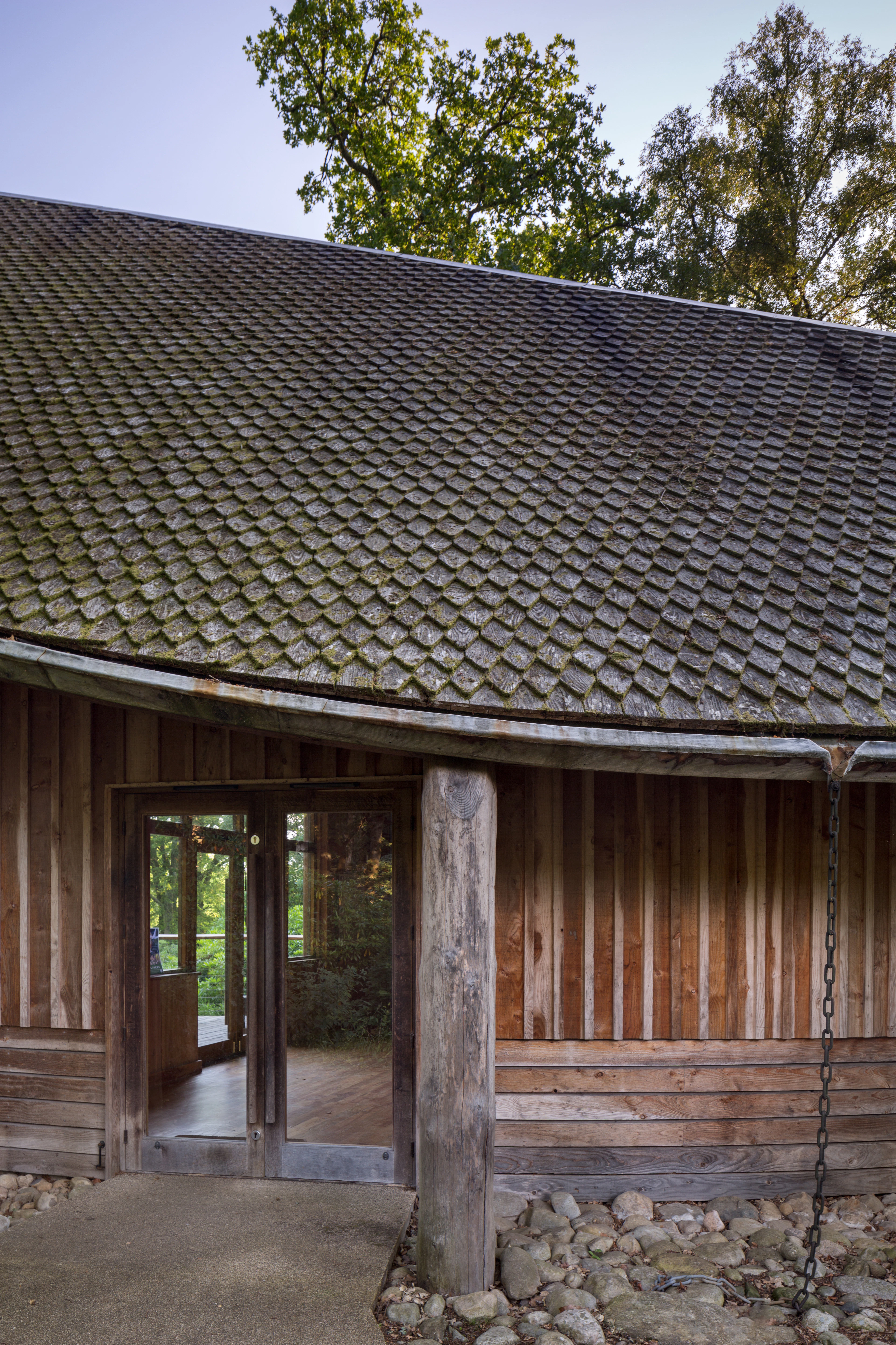 A wooden pavilion with an angled roof