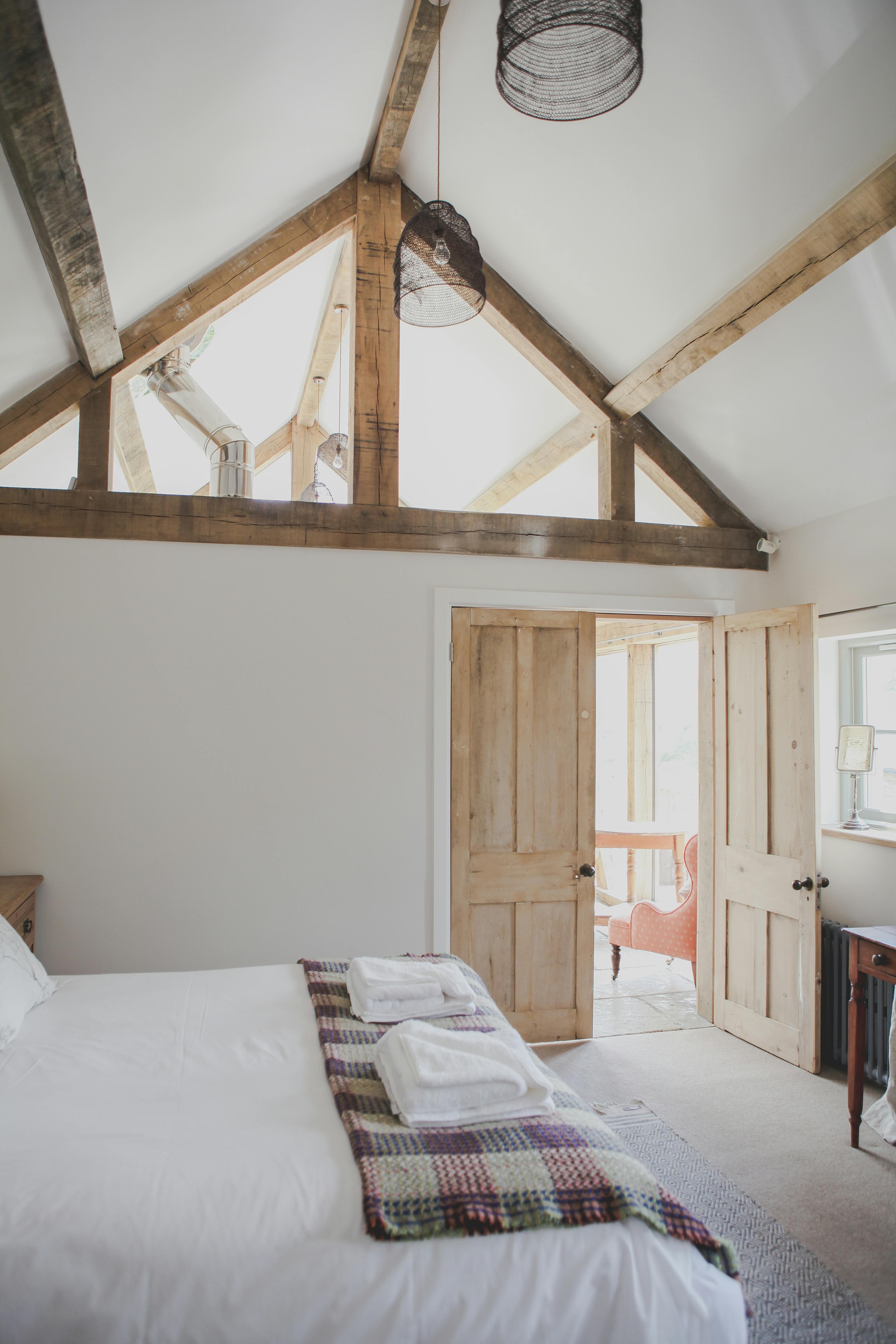 The bedroom of an oak framed cabin