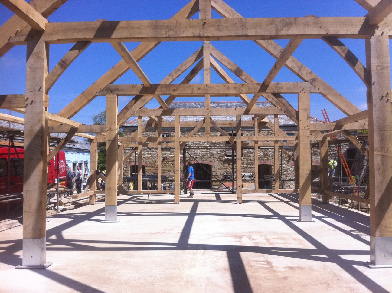 On a construction site the frame for an oak framed wedding barn is installed
