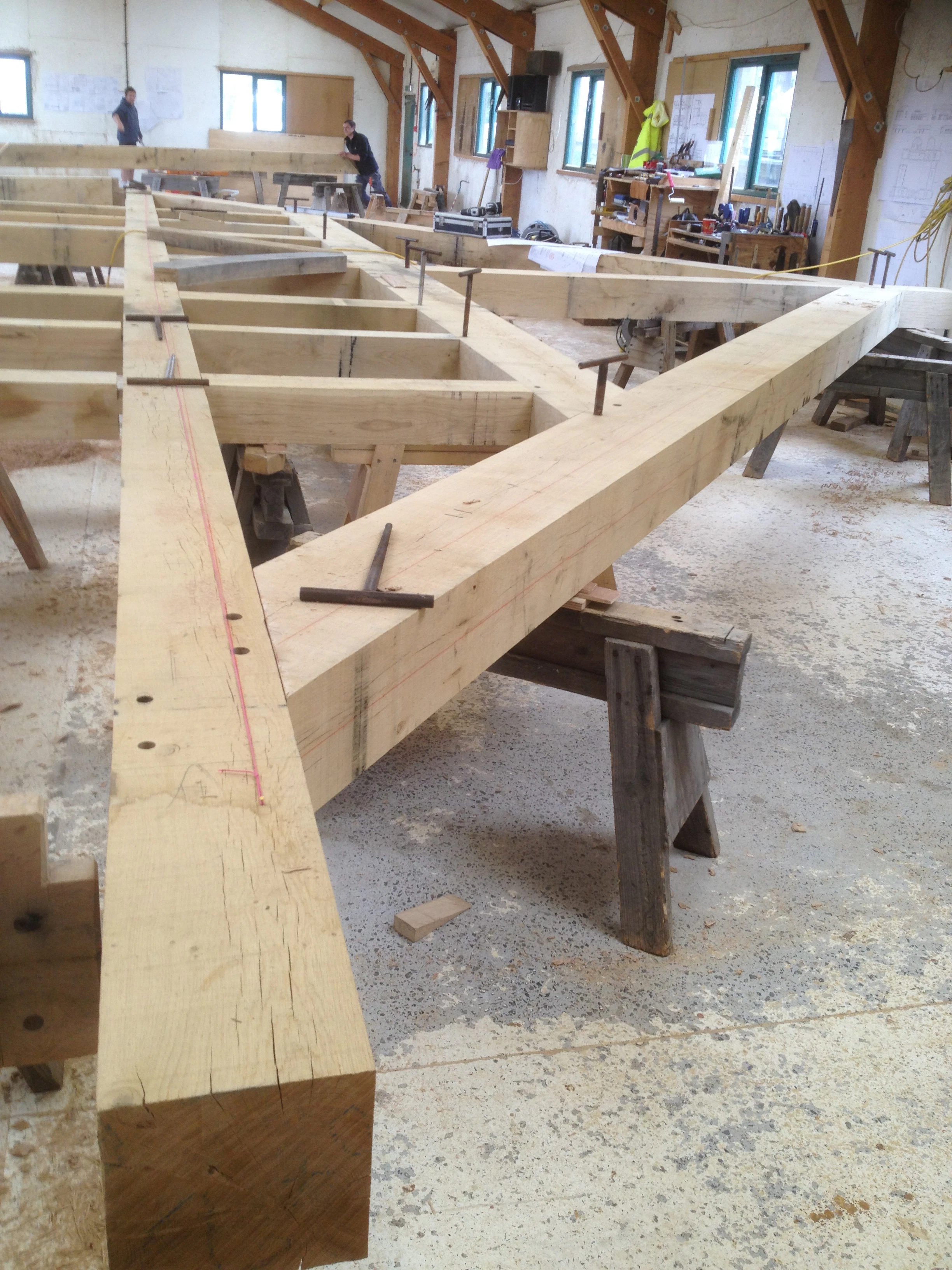 A large oak frame being manufactured by hand in a workshop