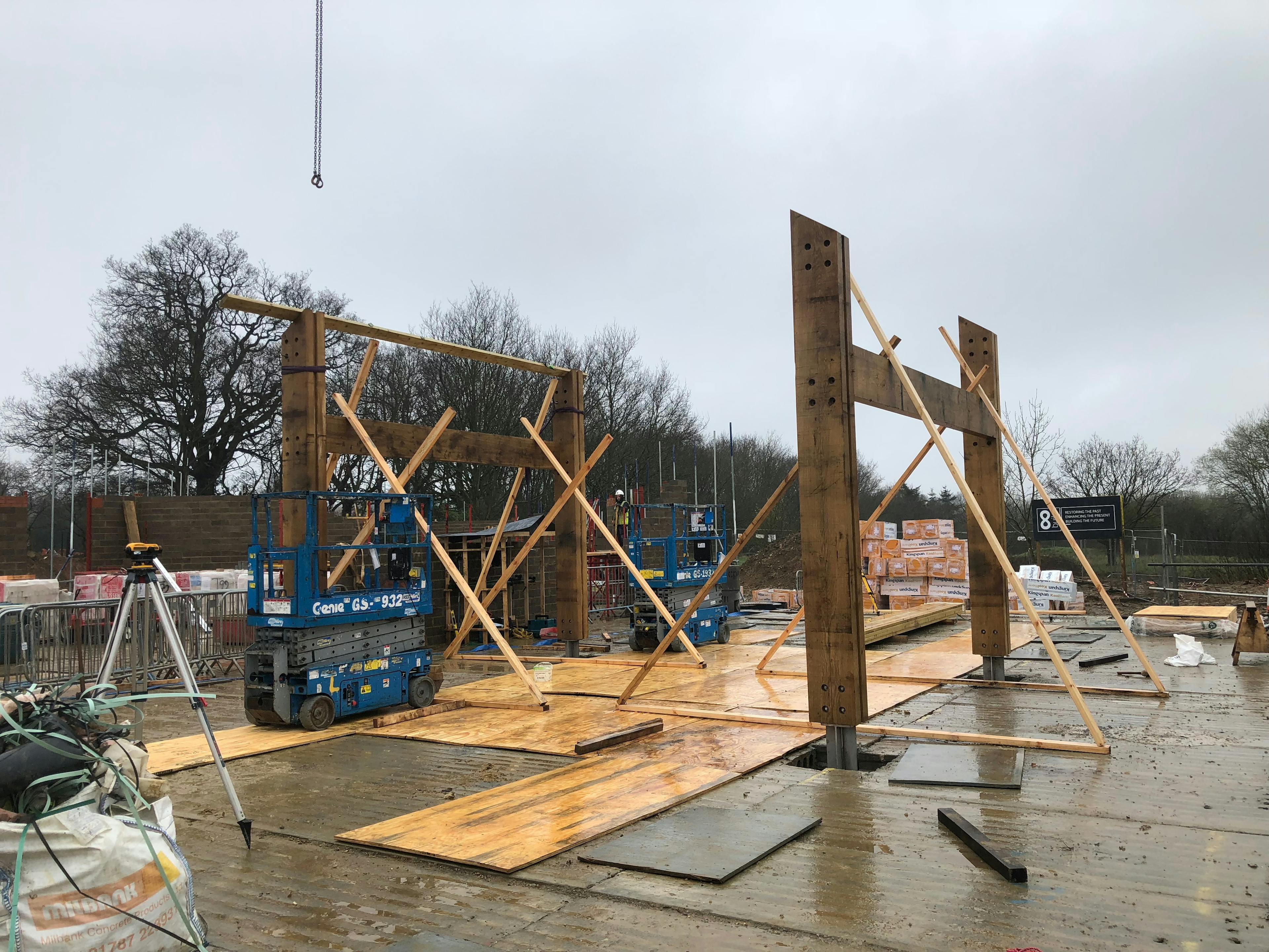 On a construction site an oak portal frame is installed