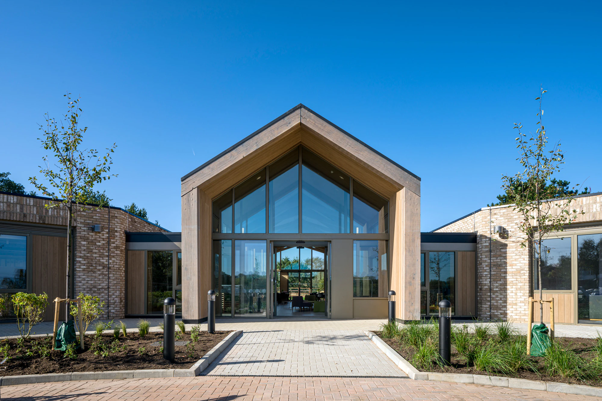 A single storey brick children's hospital with a large oak framed atrium