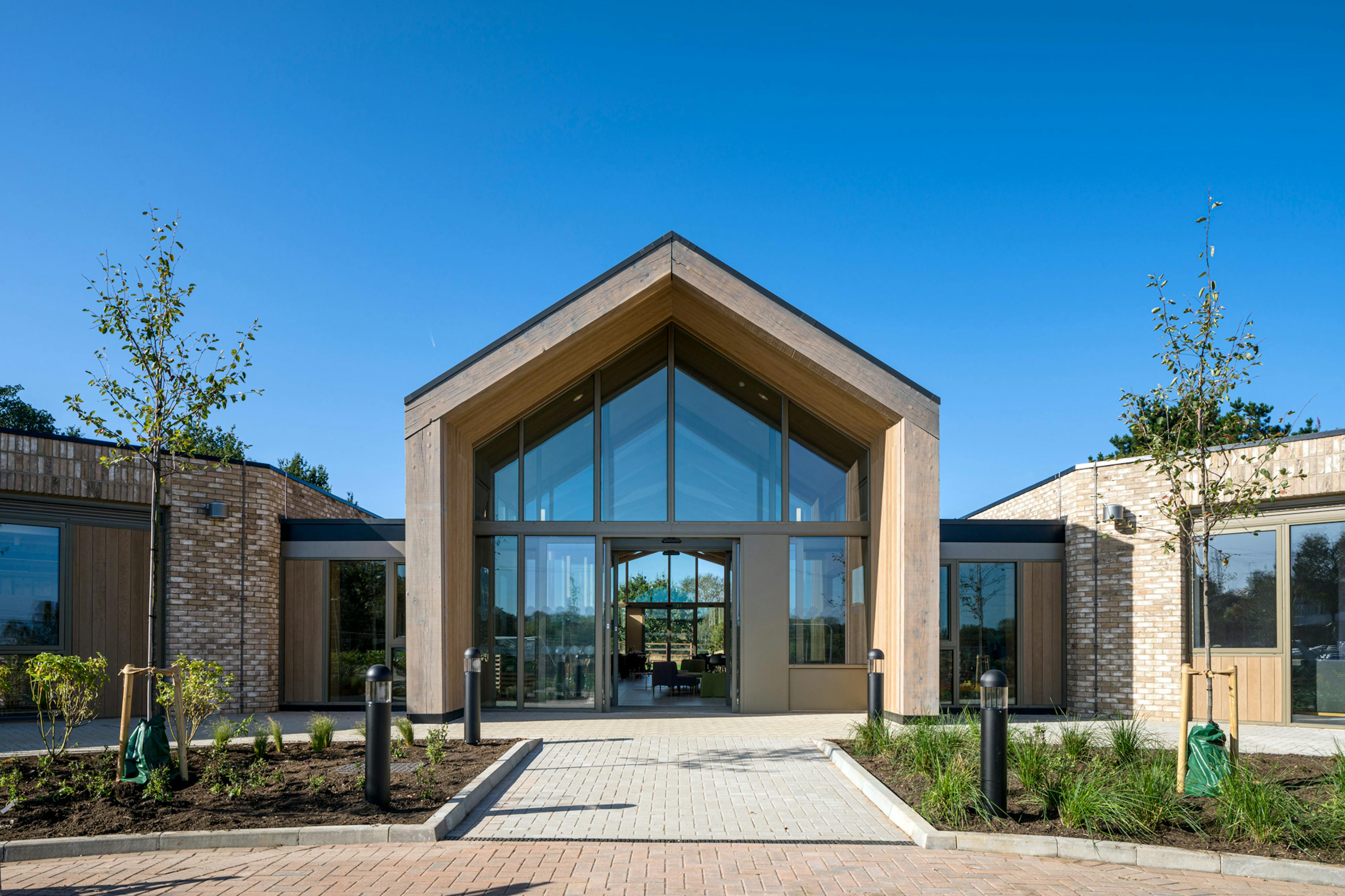 A single storey brick children's hospital with a large oak framed atrium