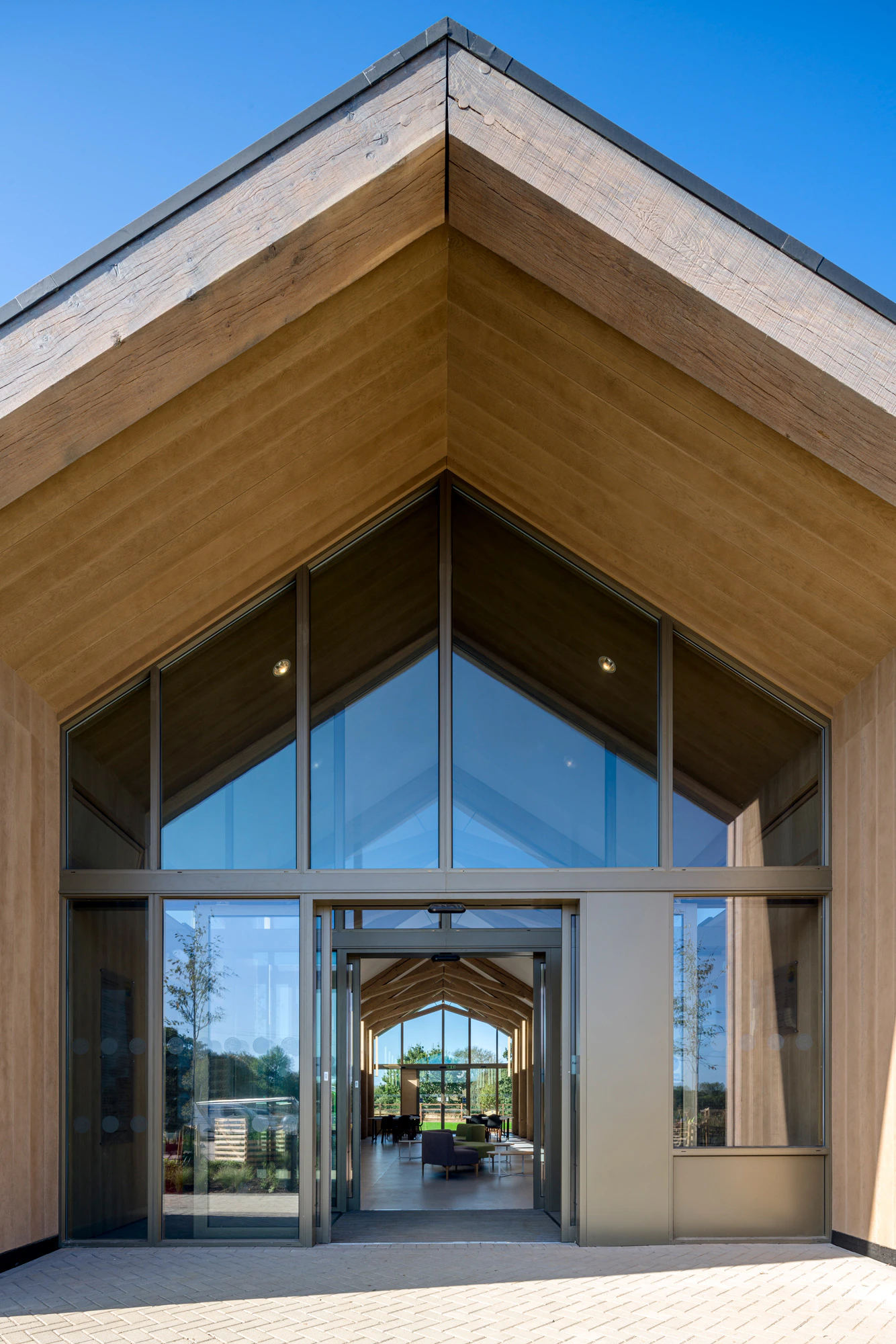 A single storey brick children's hospital with a large oak framed atrium
