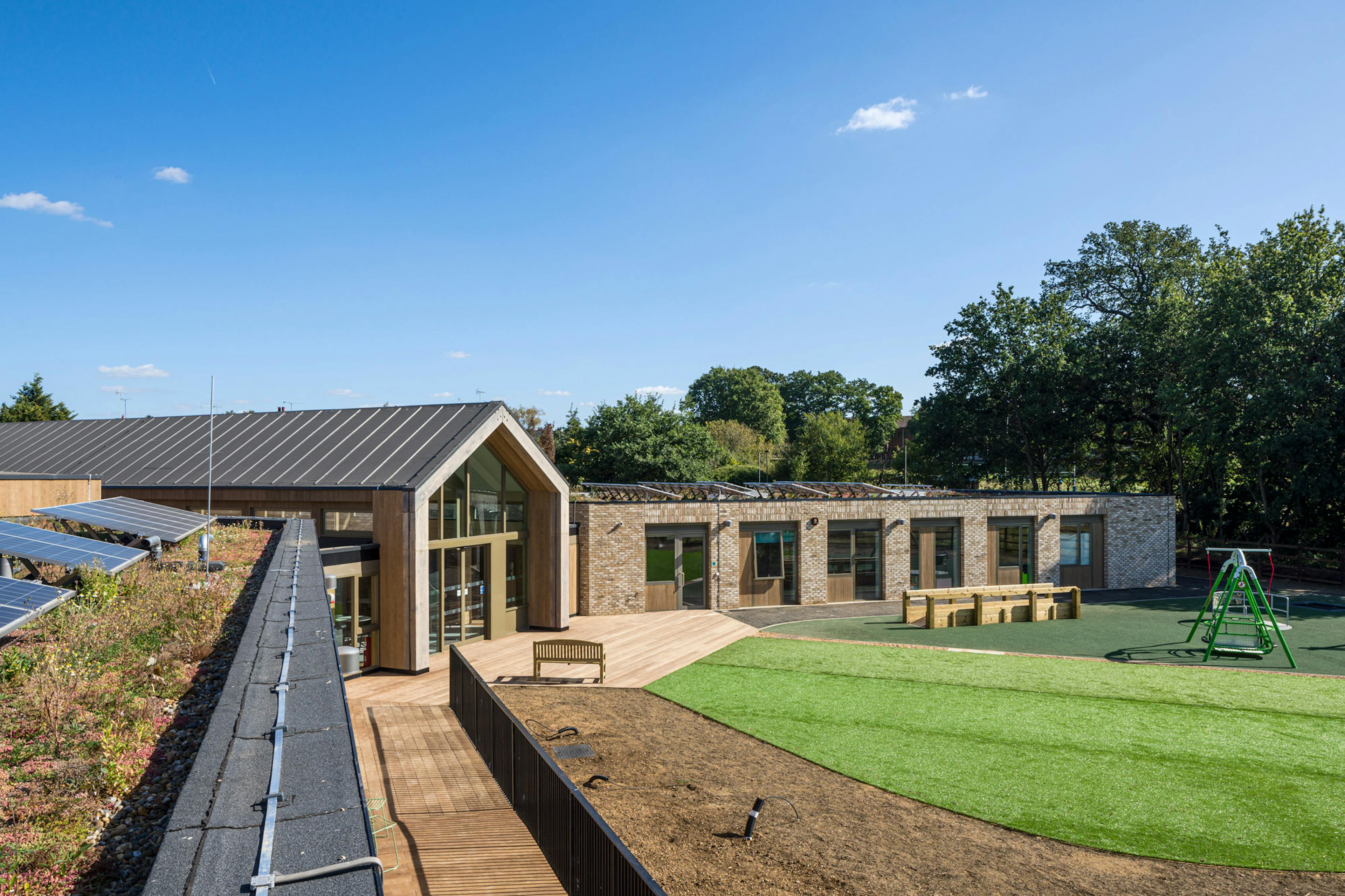 A single storey brick children's hospital with a large oak framed atrium