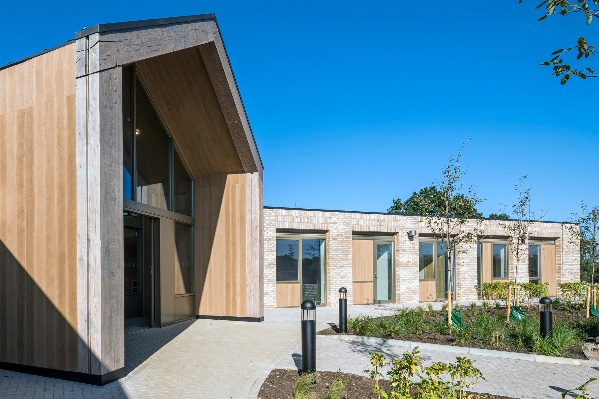 A single storey brick children's hospital with a large oak framed atrium