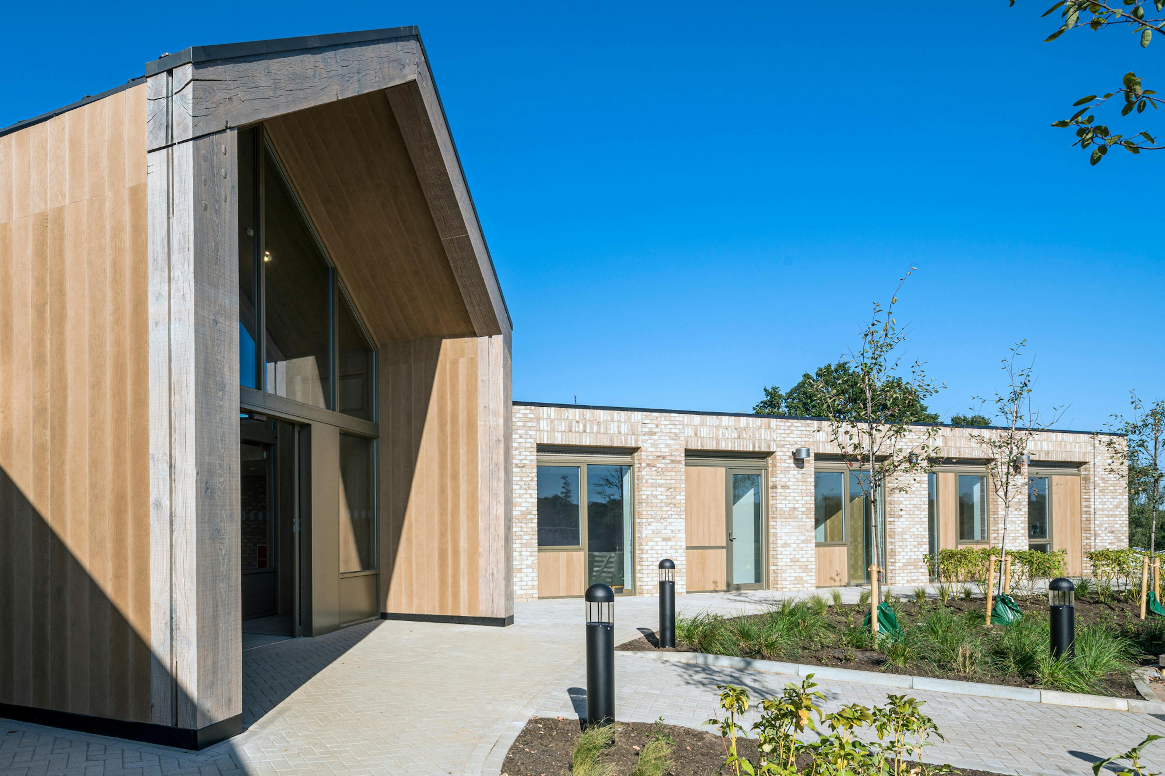 A single storey brick children's hospital with a large oak framed atrium
