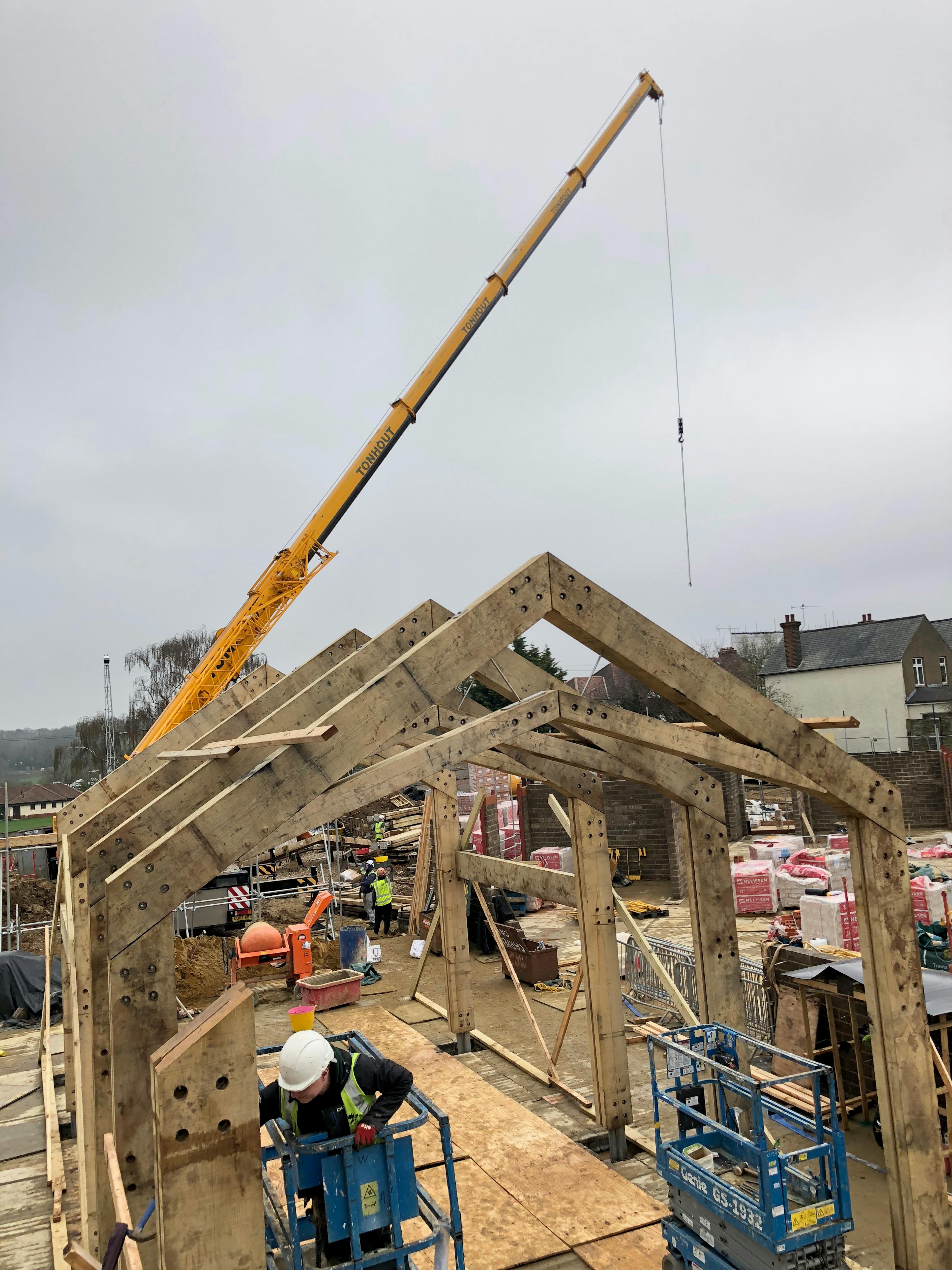 On a construction site an oak portal frame is installed