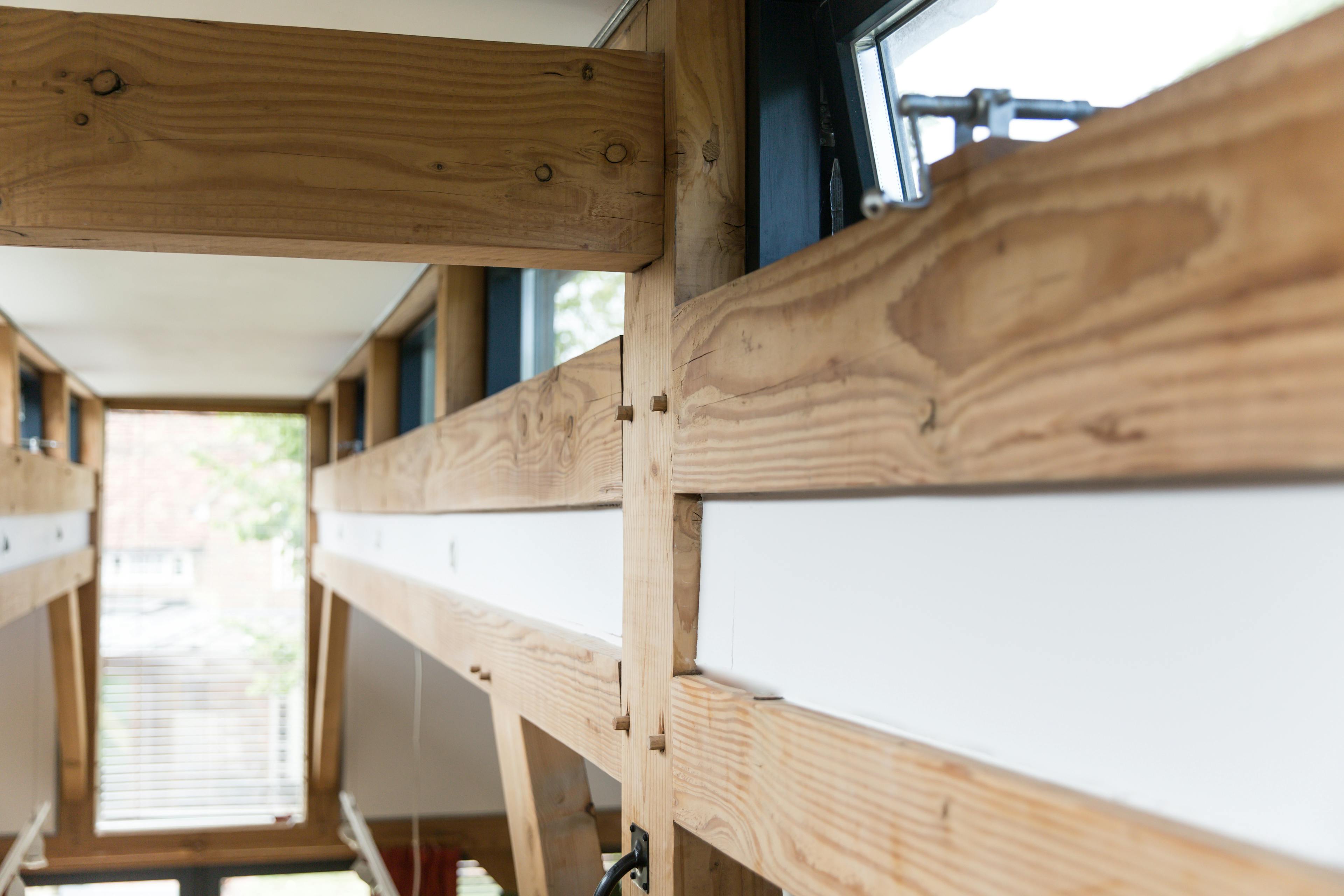 A mezzanine space above an open plan Douglas fir framed living room