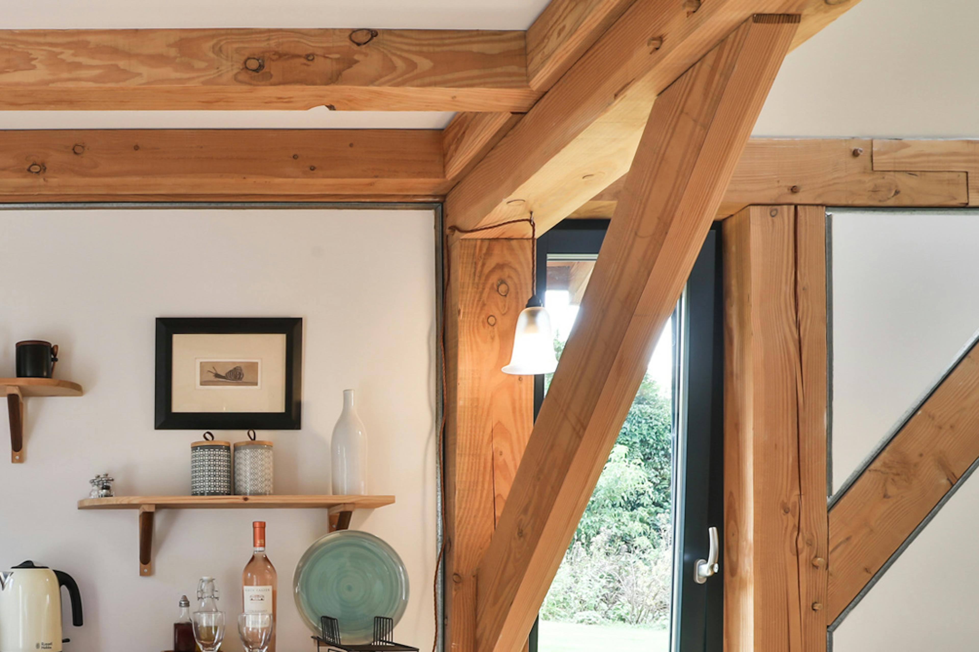A laid dining table and chairs in a Douglas fir framed living room
