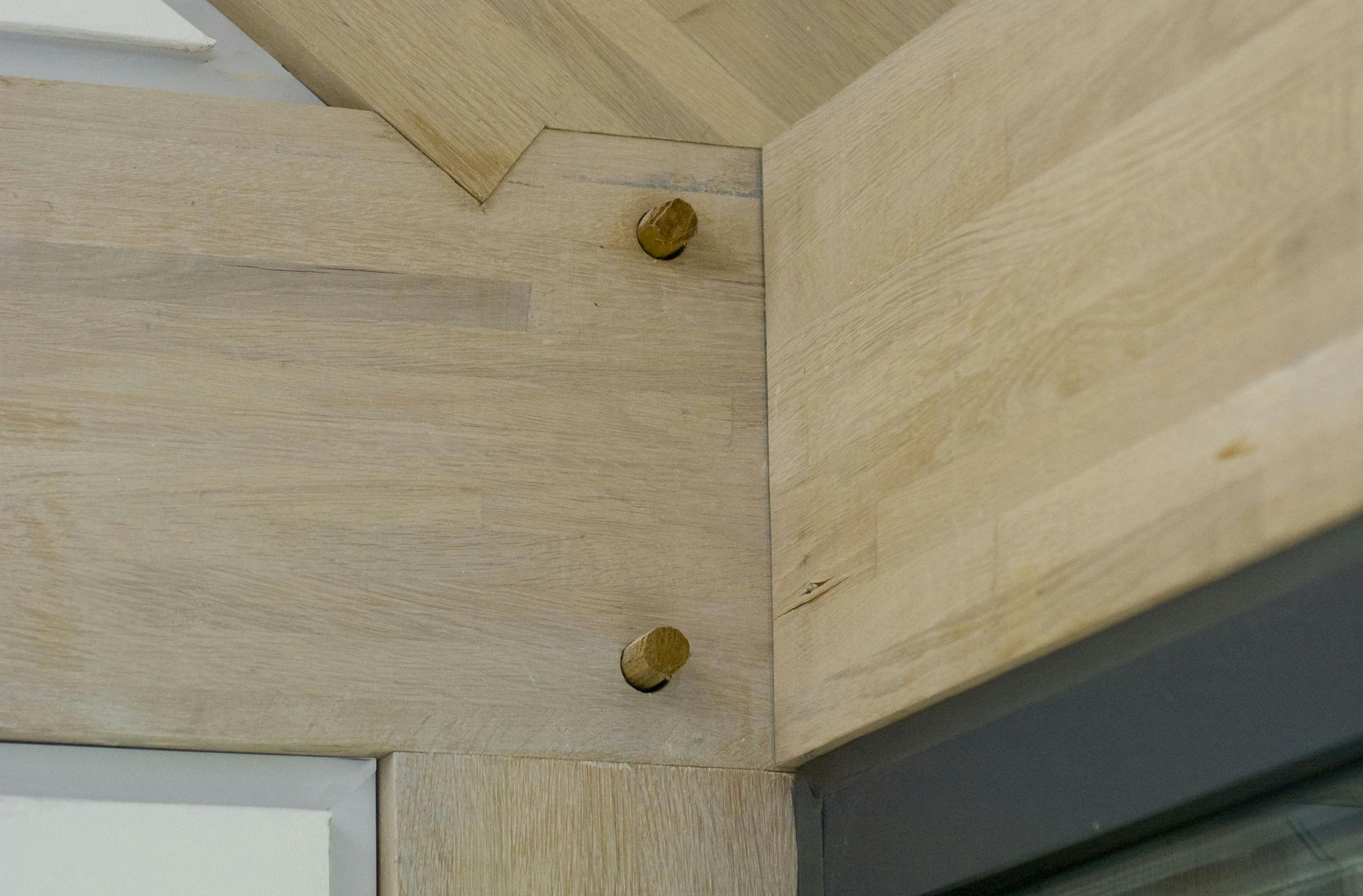 A join of a section of the frame with wooden pegs in an oak glulam framed house