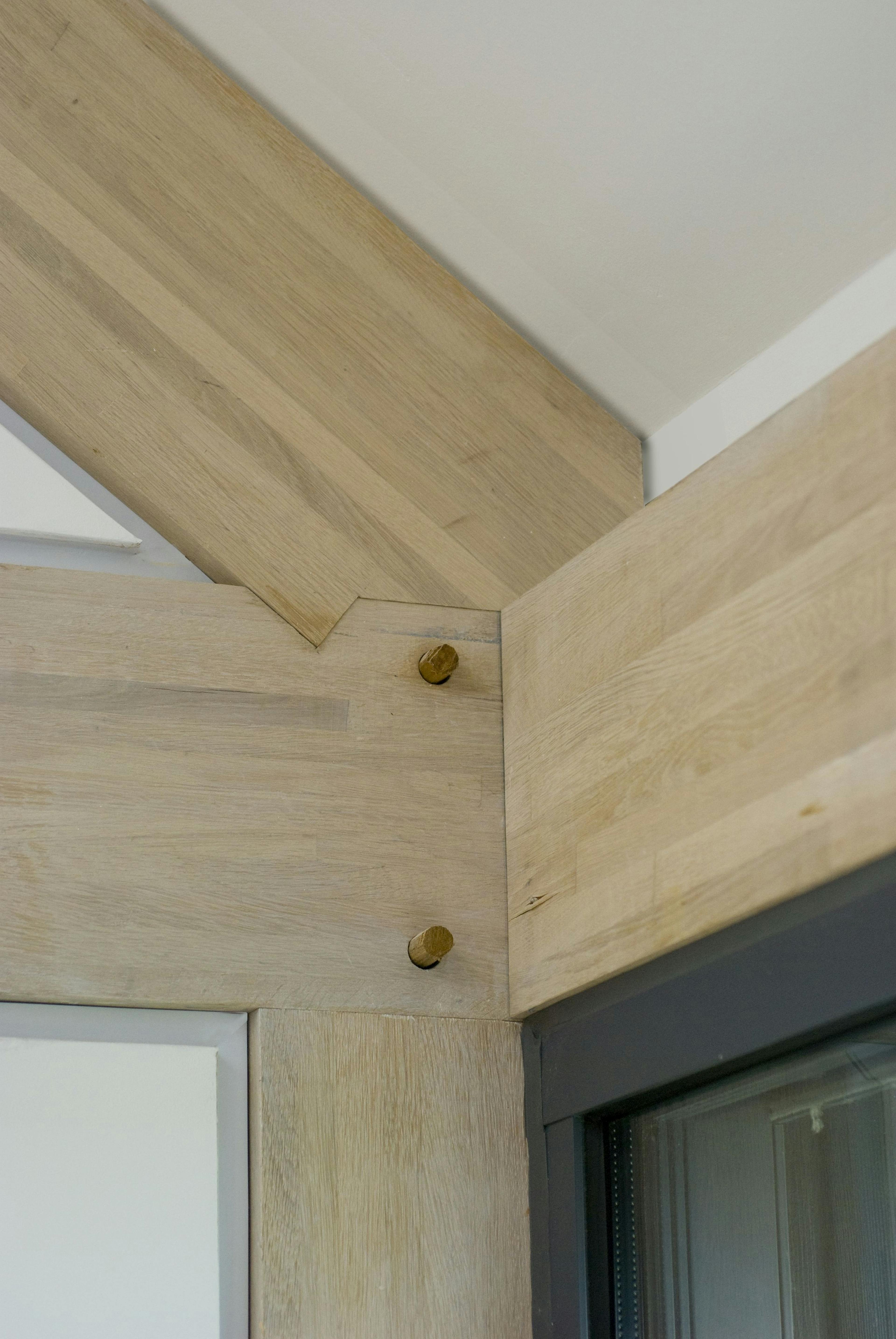 A join of a section of the frame with wooden pegs in an oak glulam framed house