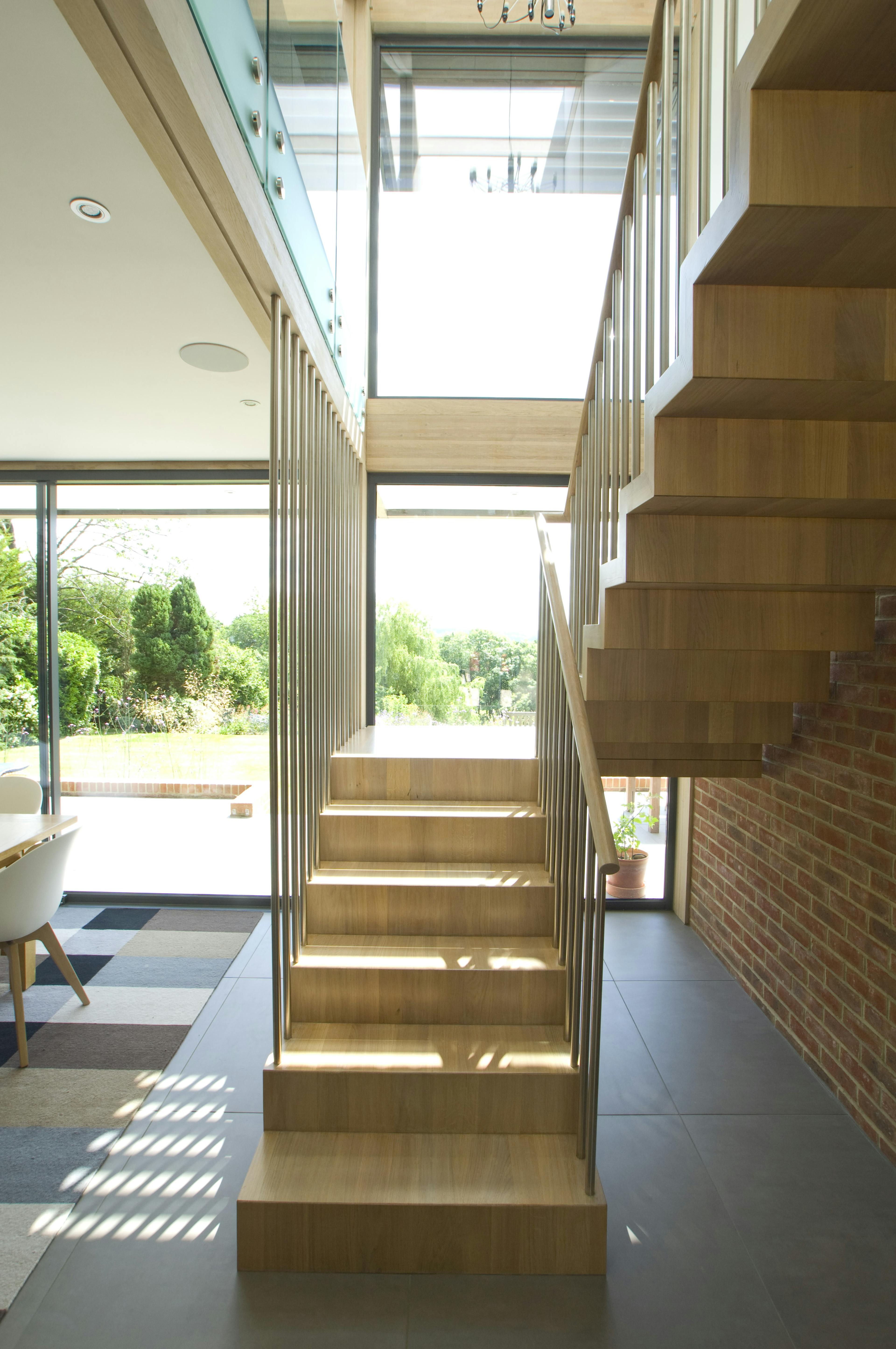 The wooden stairs and entranceway within an oak glulam framed house