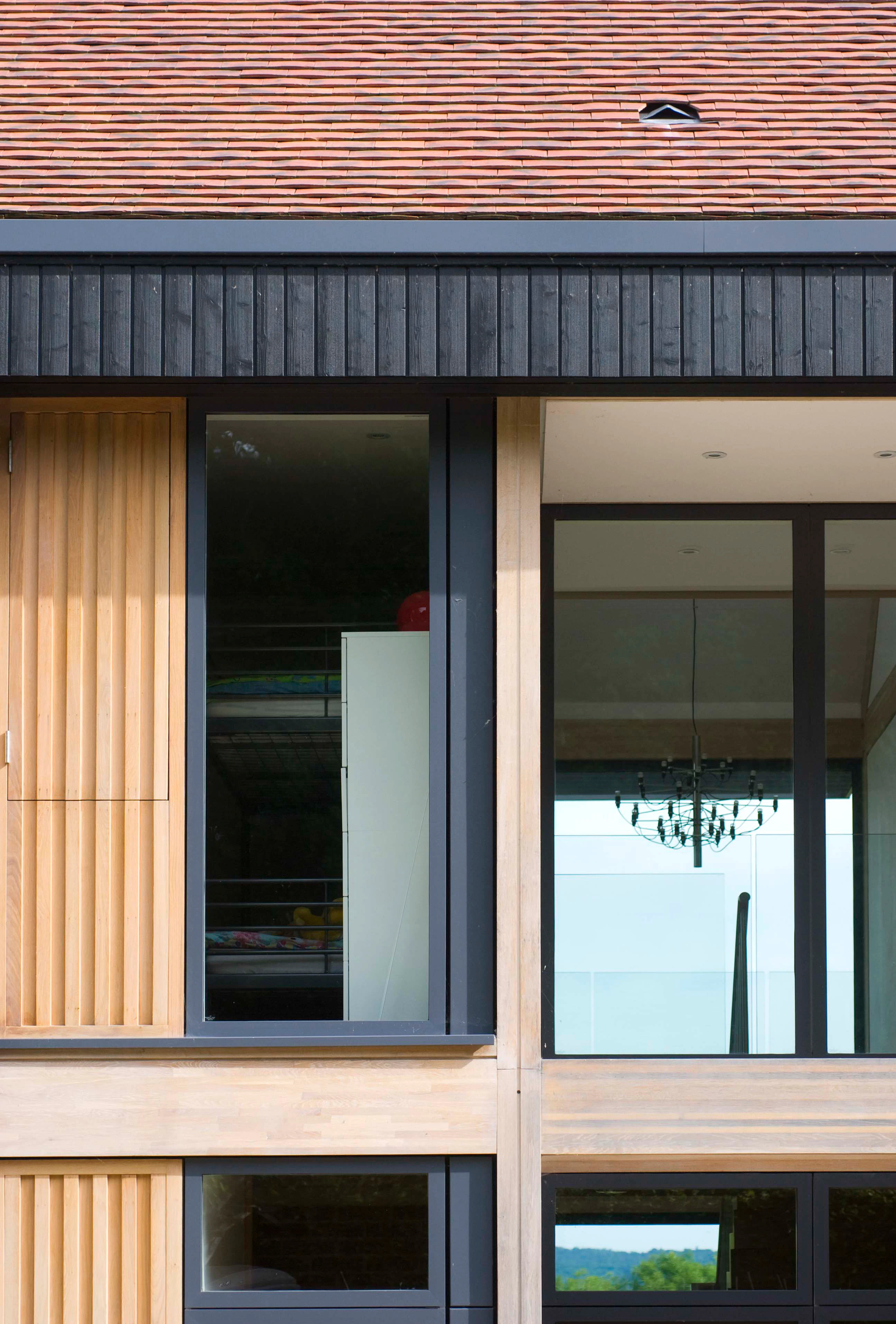 A close up image of windows on an oak glulam house