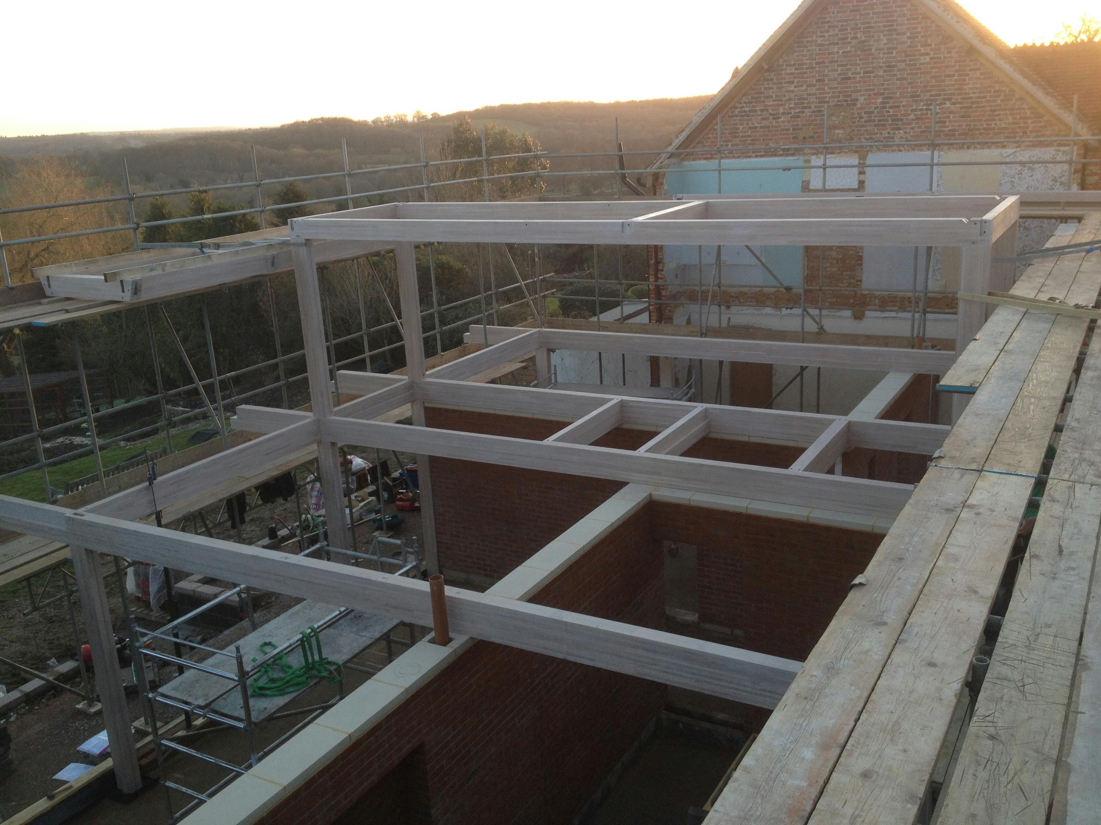 The frame of an oak glulam house during construction