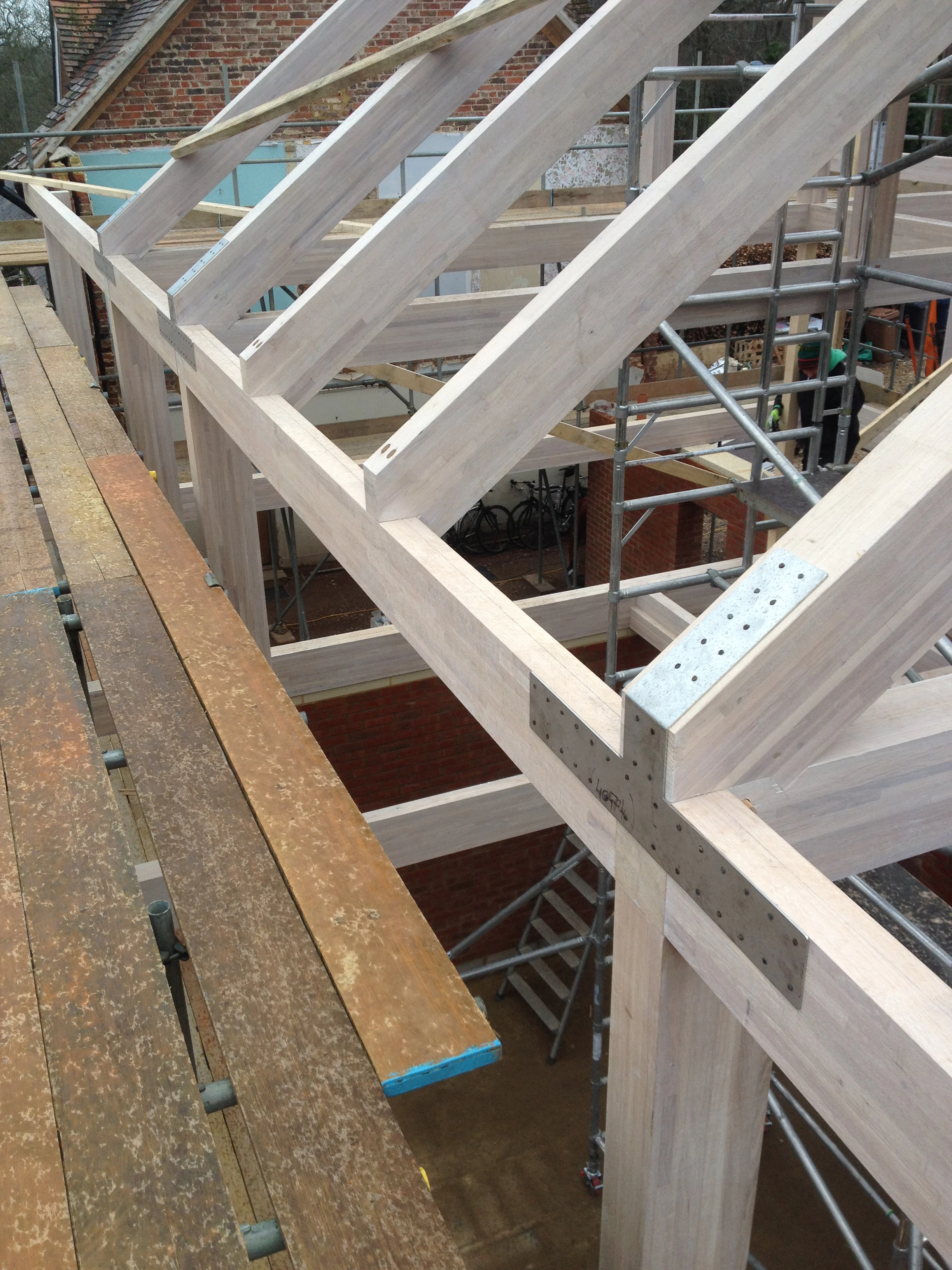 The frame of an oak glulam house with steel connection detail