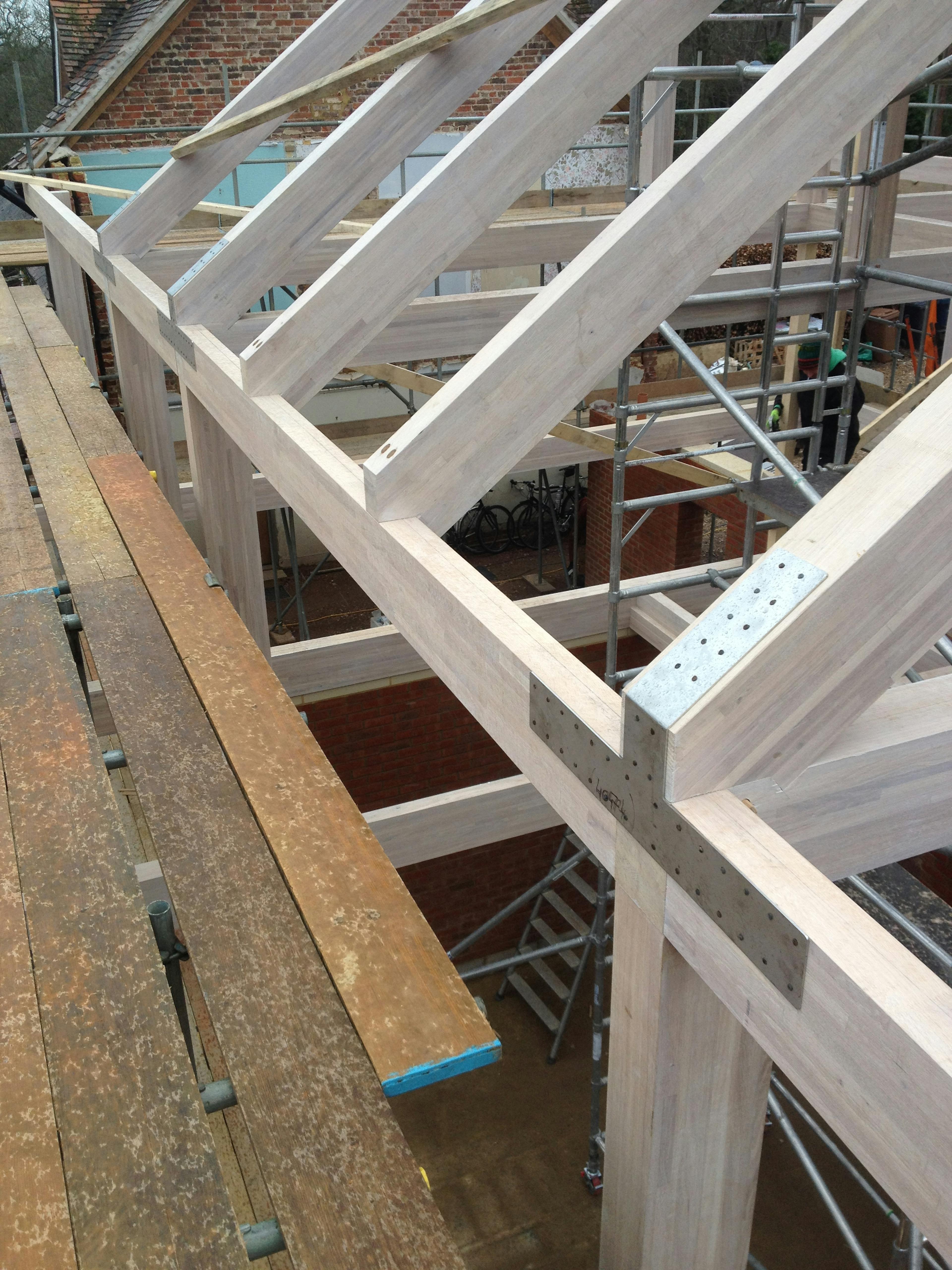 The frame of an oak glulam house with steel connection detail
