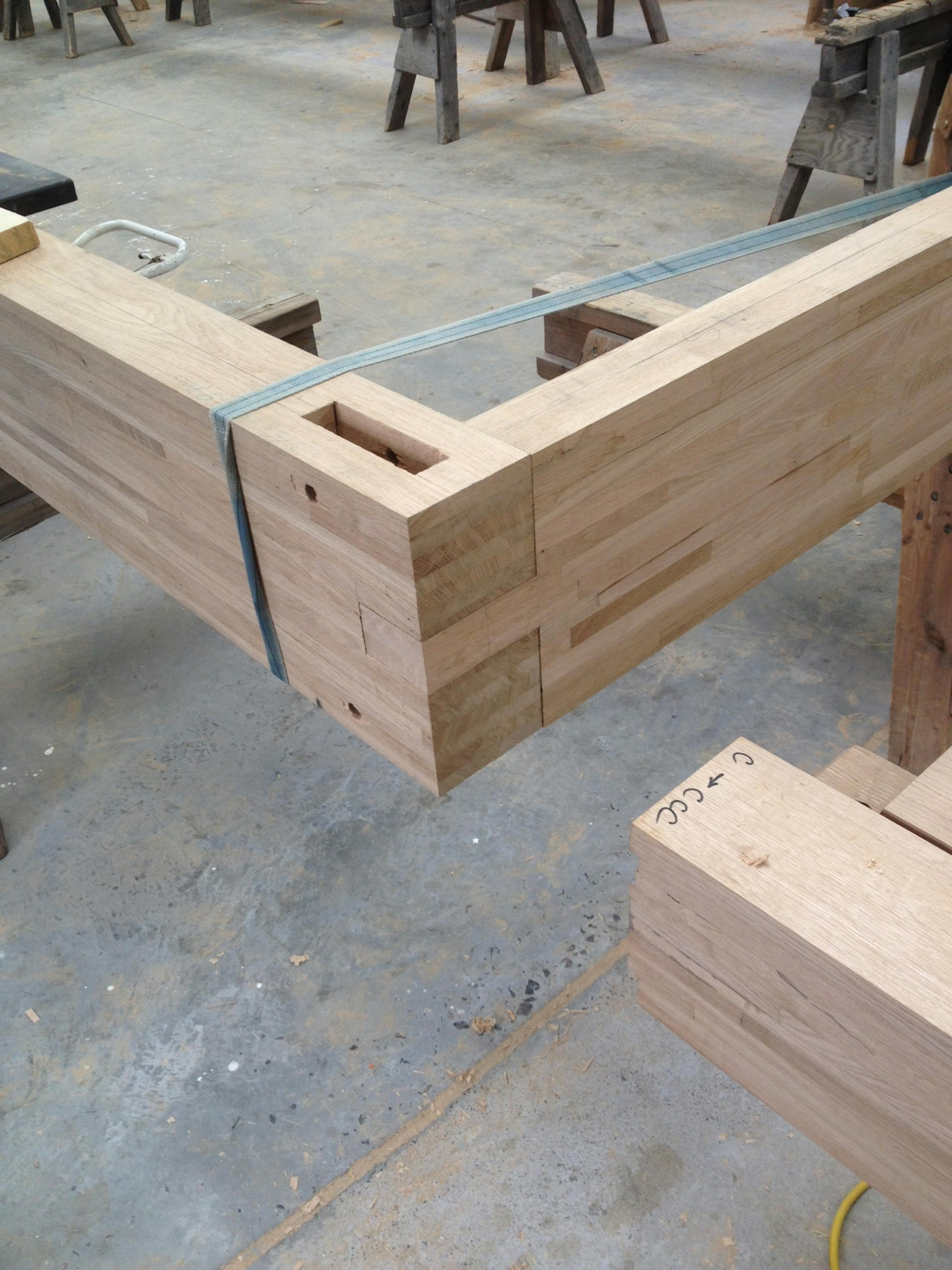 The details of an oak glulam frame being made in a workshop
