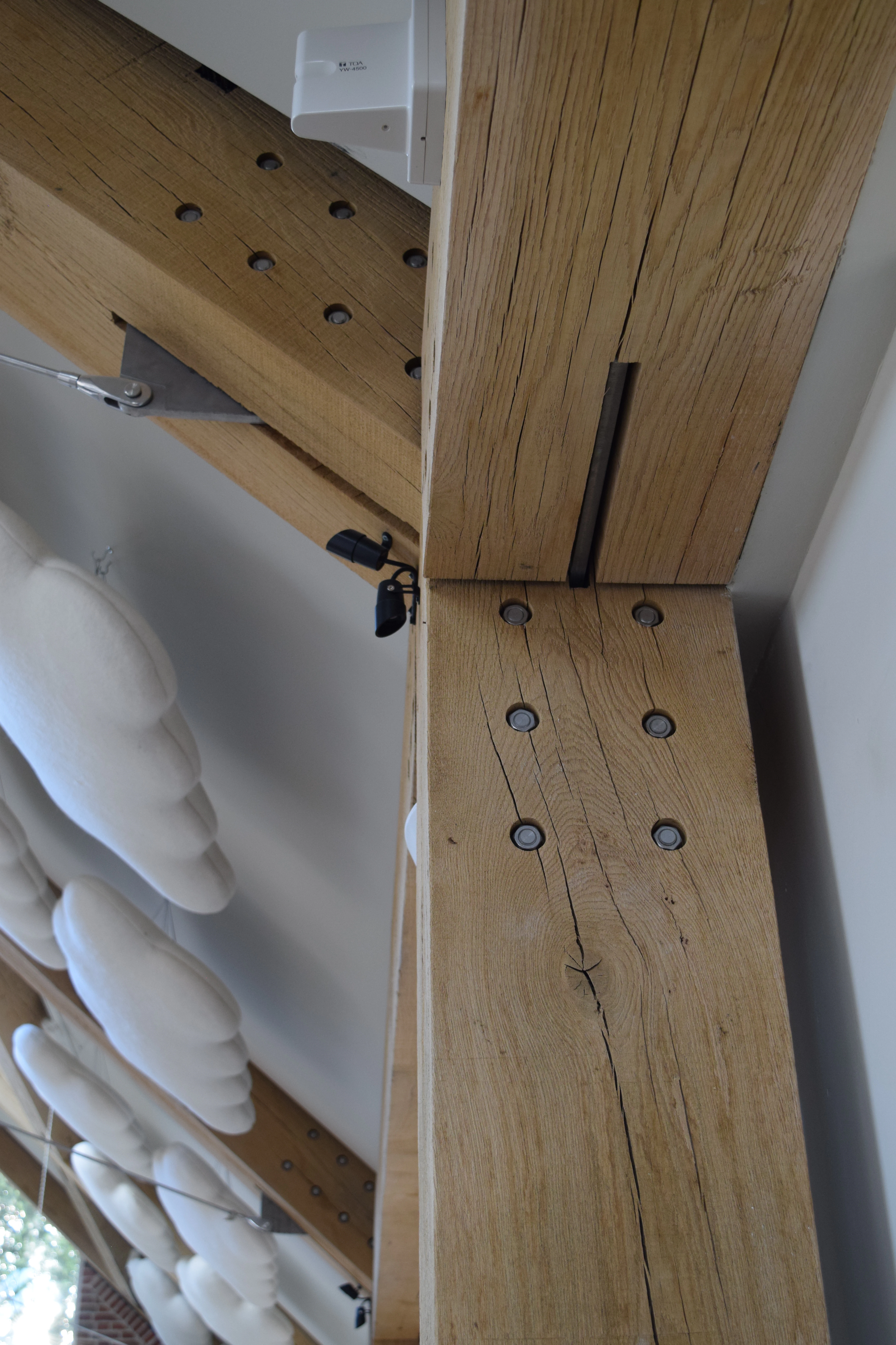 The ceiling of the Grange Hearing Dogs oak and steel framed gift shop showing a steel bolts and flitch plates