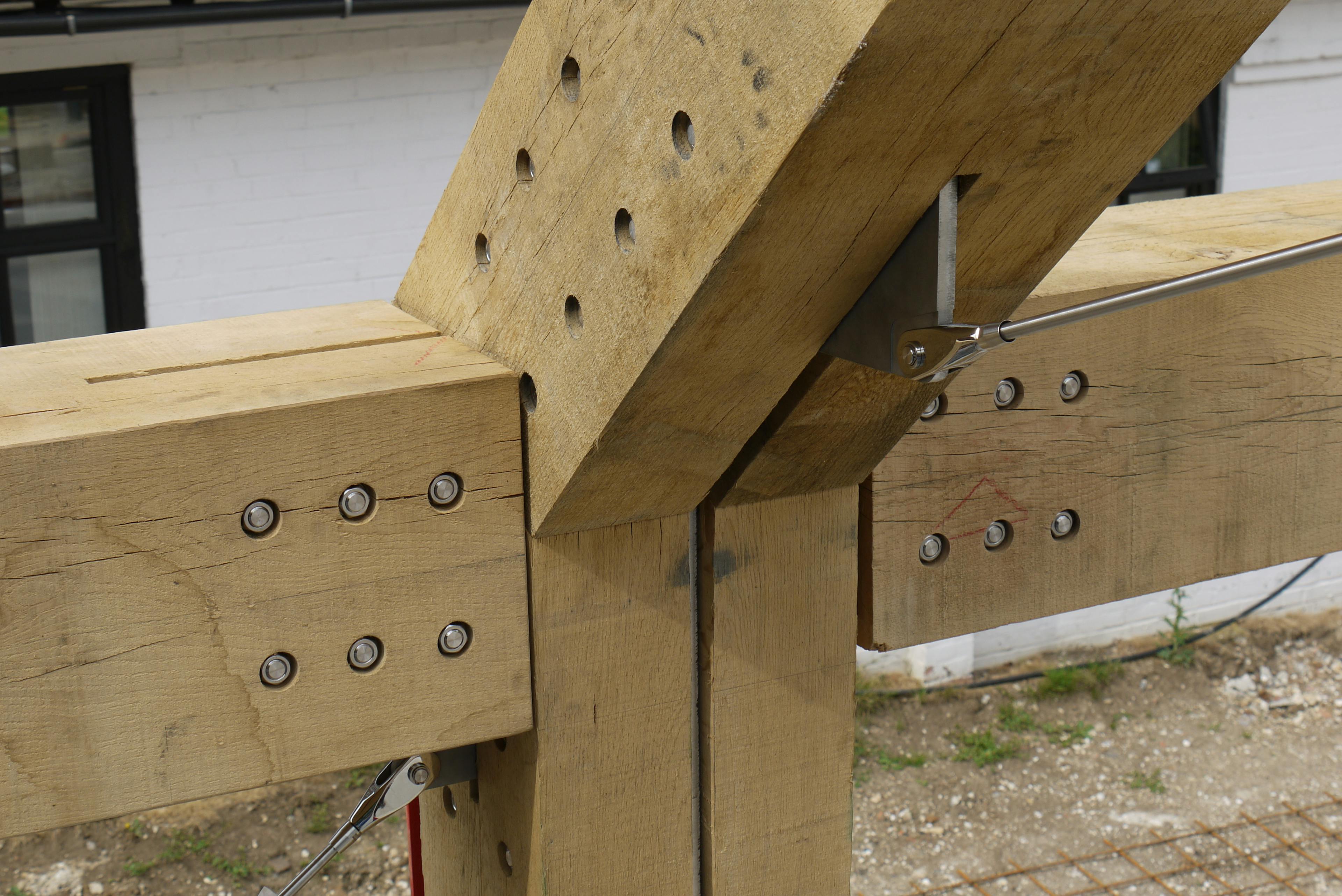 Steel bolts, a tie rod and flitch plate in an oak frame 