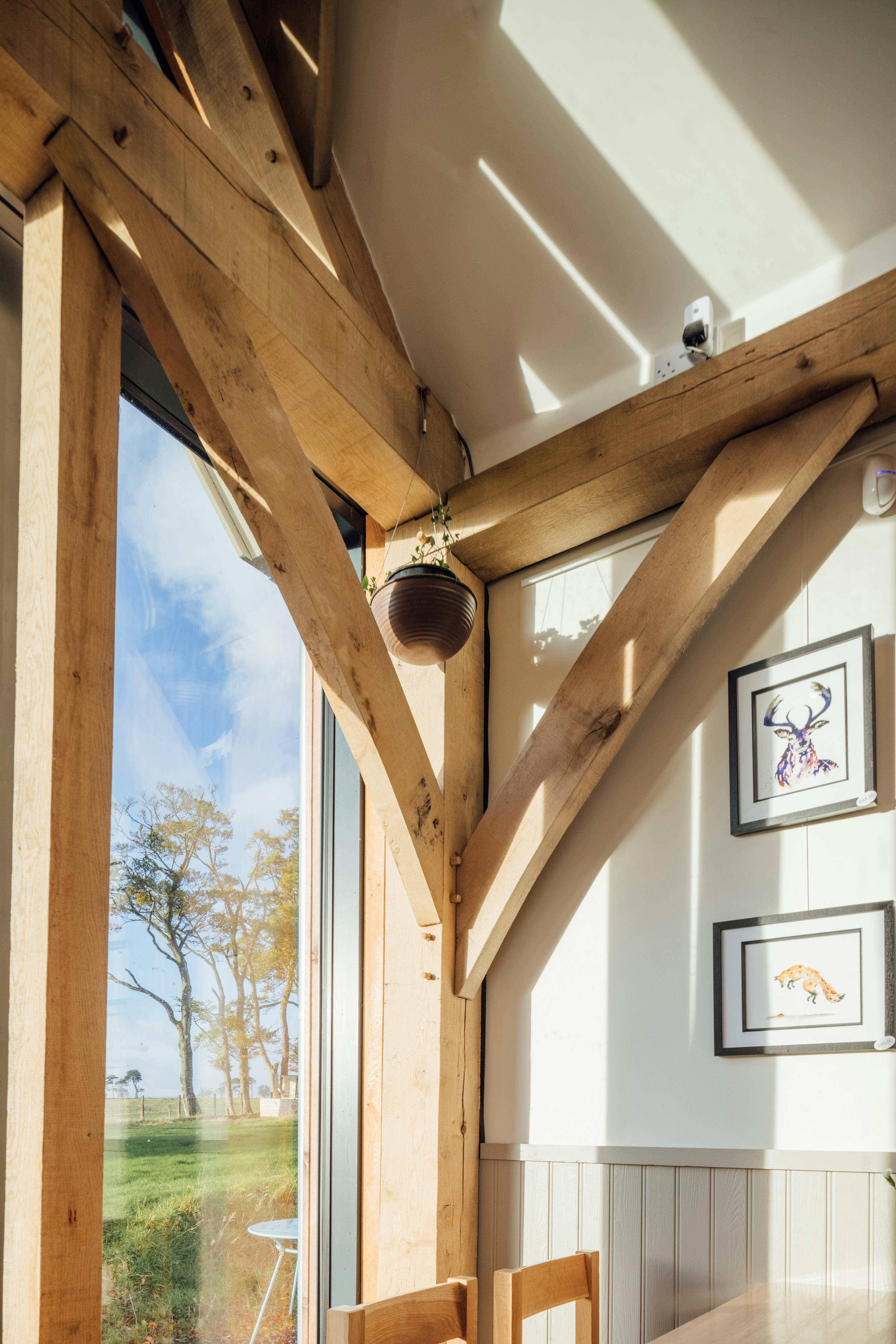A detail of an oak post joint in an oak framed farm shop 
