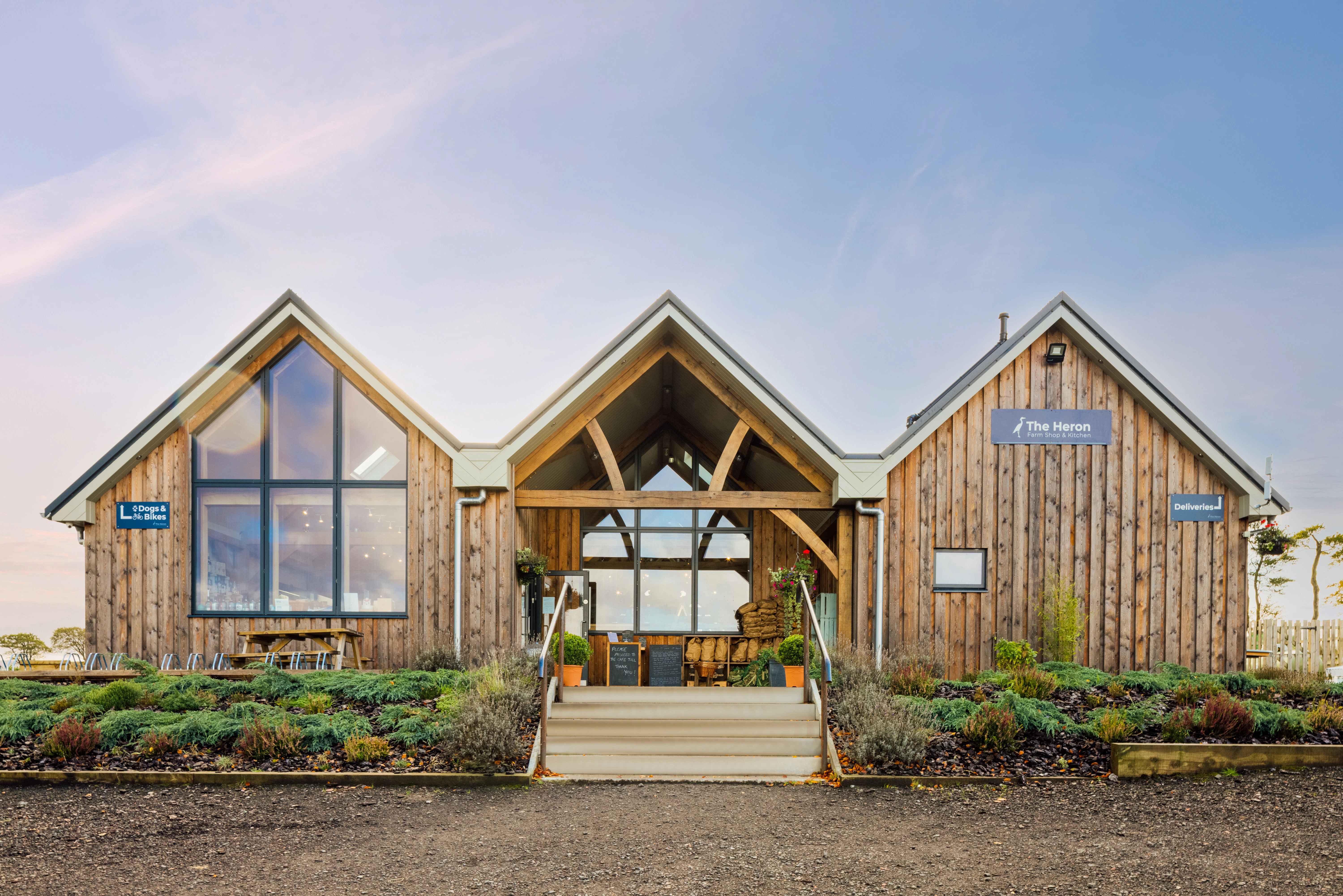 A 3 barn timber clad oak framed farm shop and cafe with an oak framed entrance