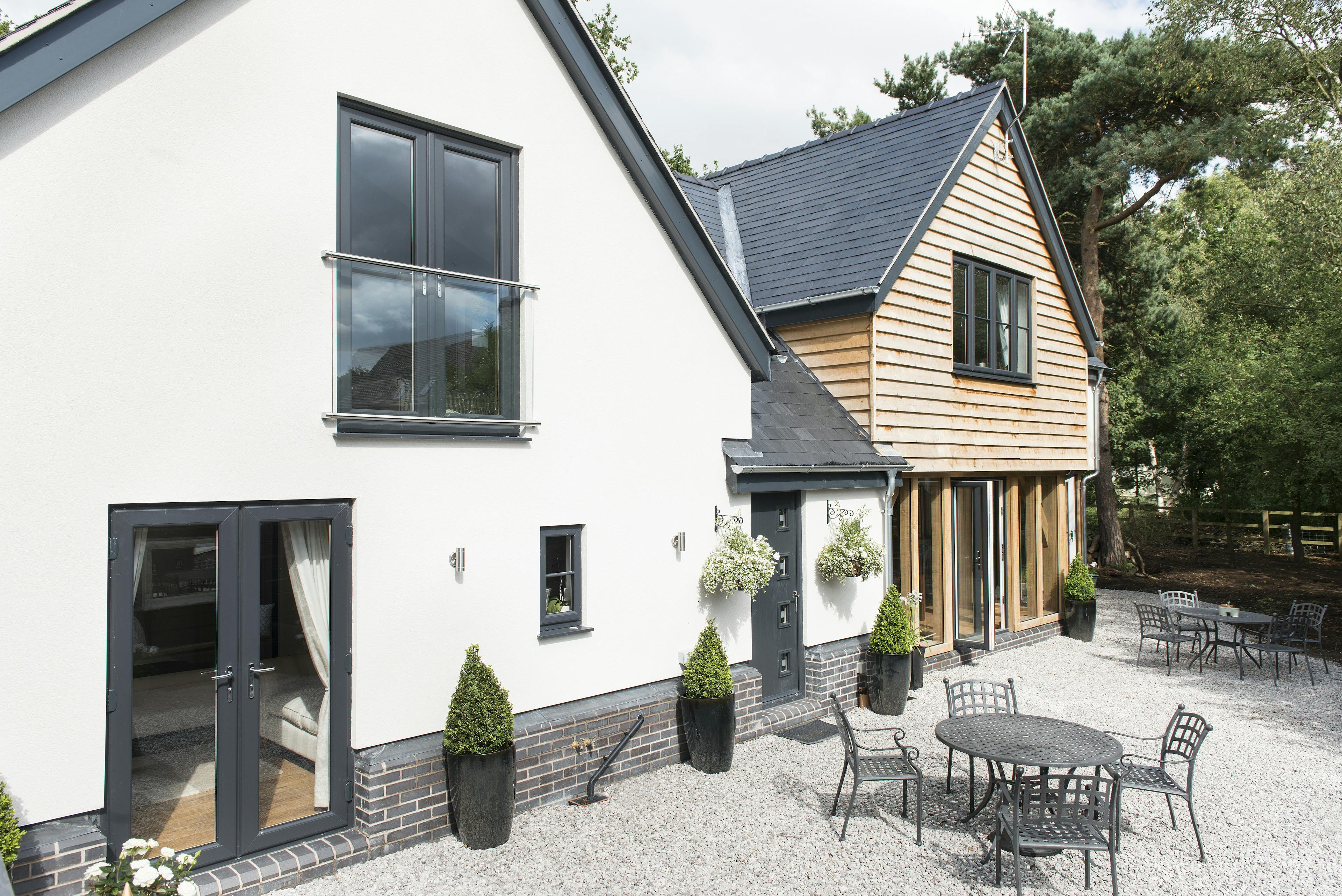 A timber clad oak framed home with outdoor seating