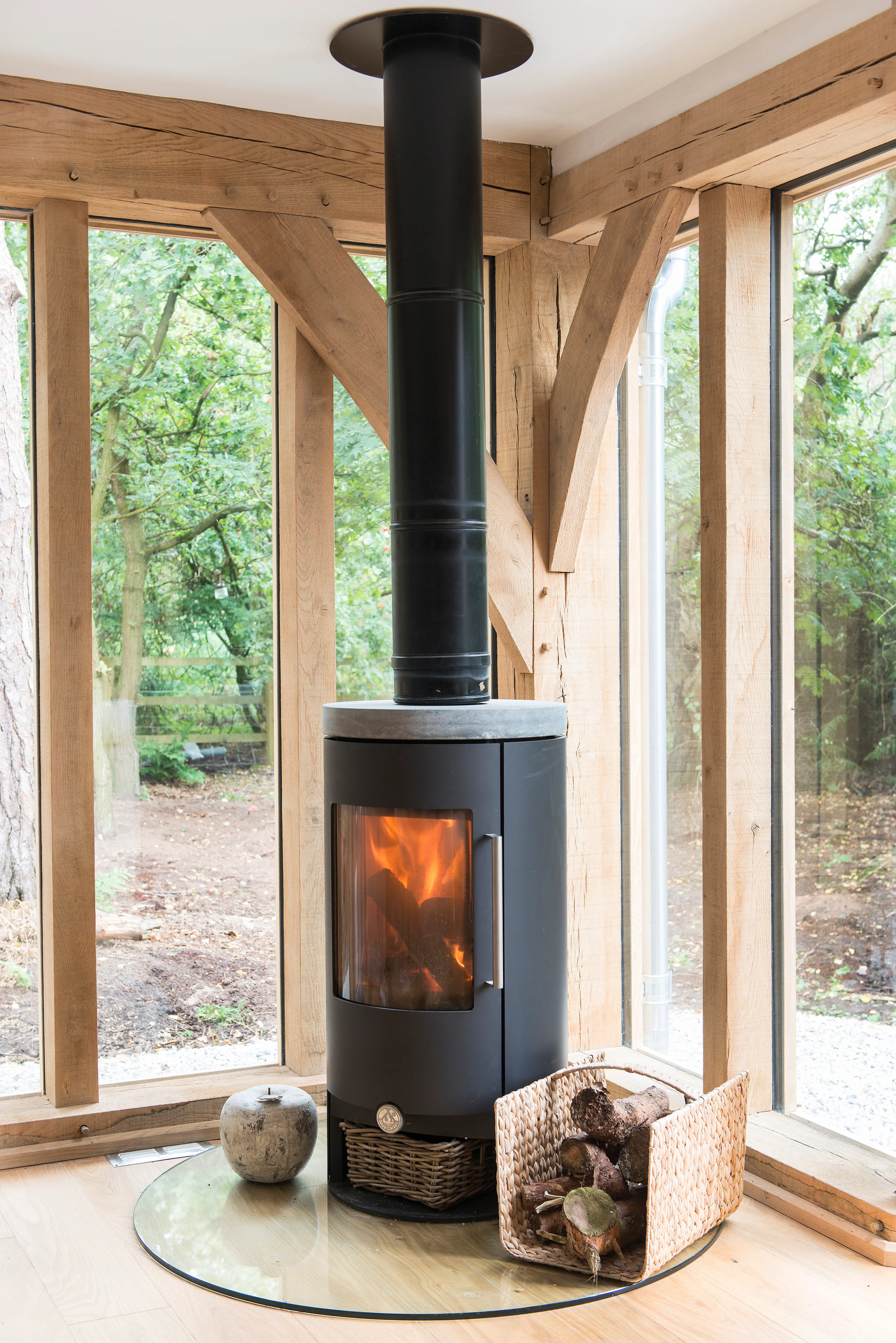A log burner in the sitting room of an oak framed home