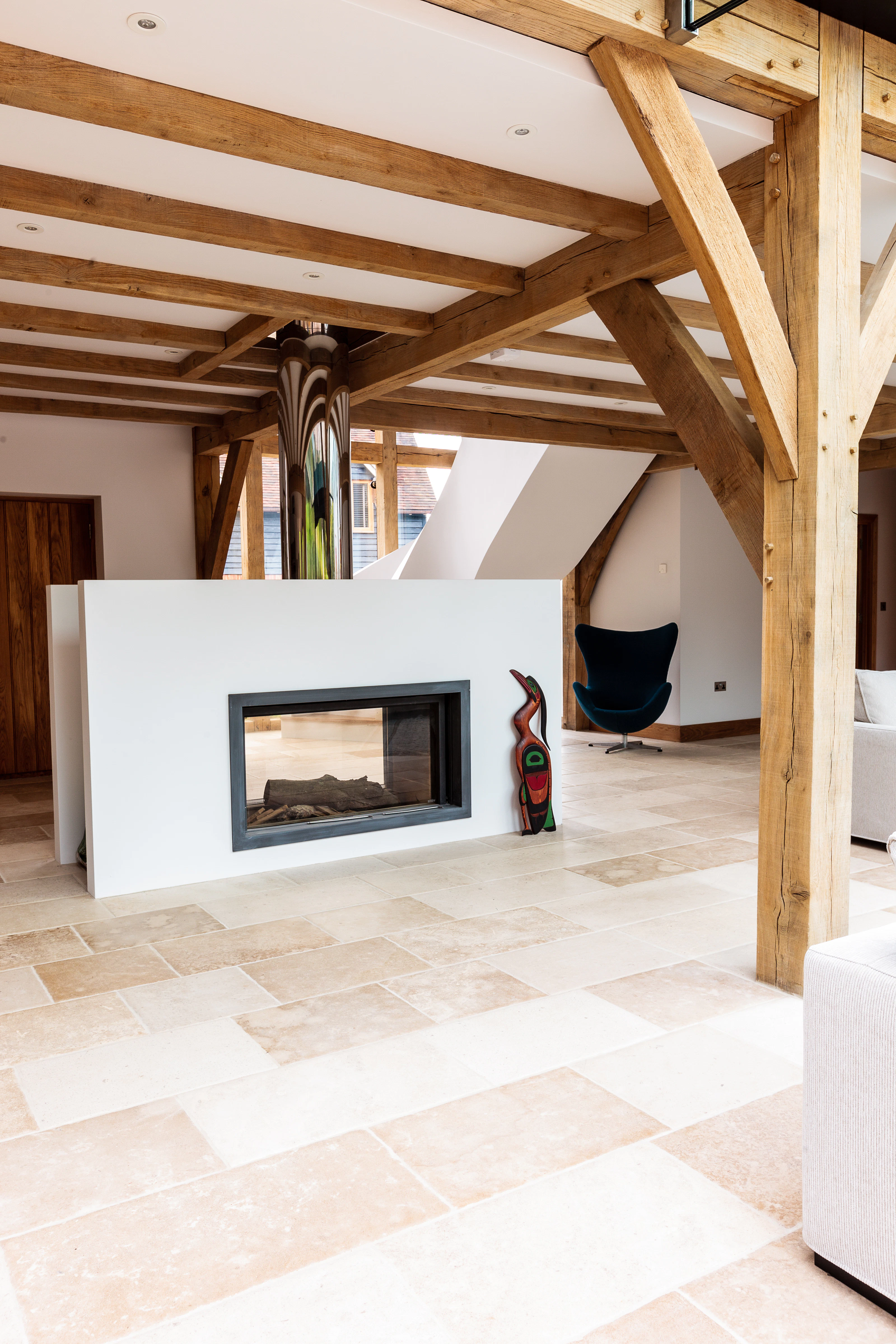 A modern oak framed room with a white fireplace