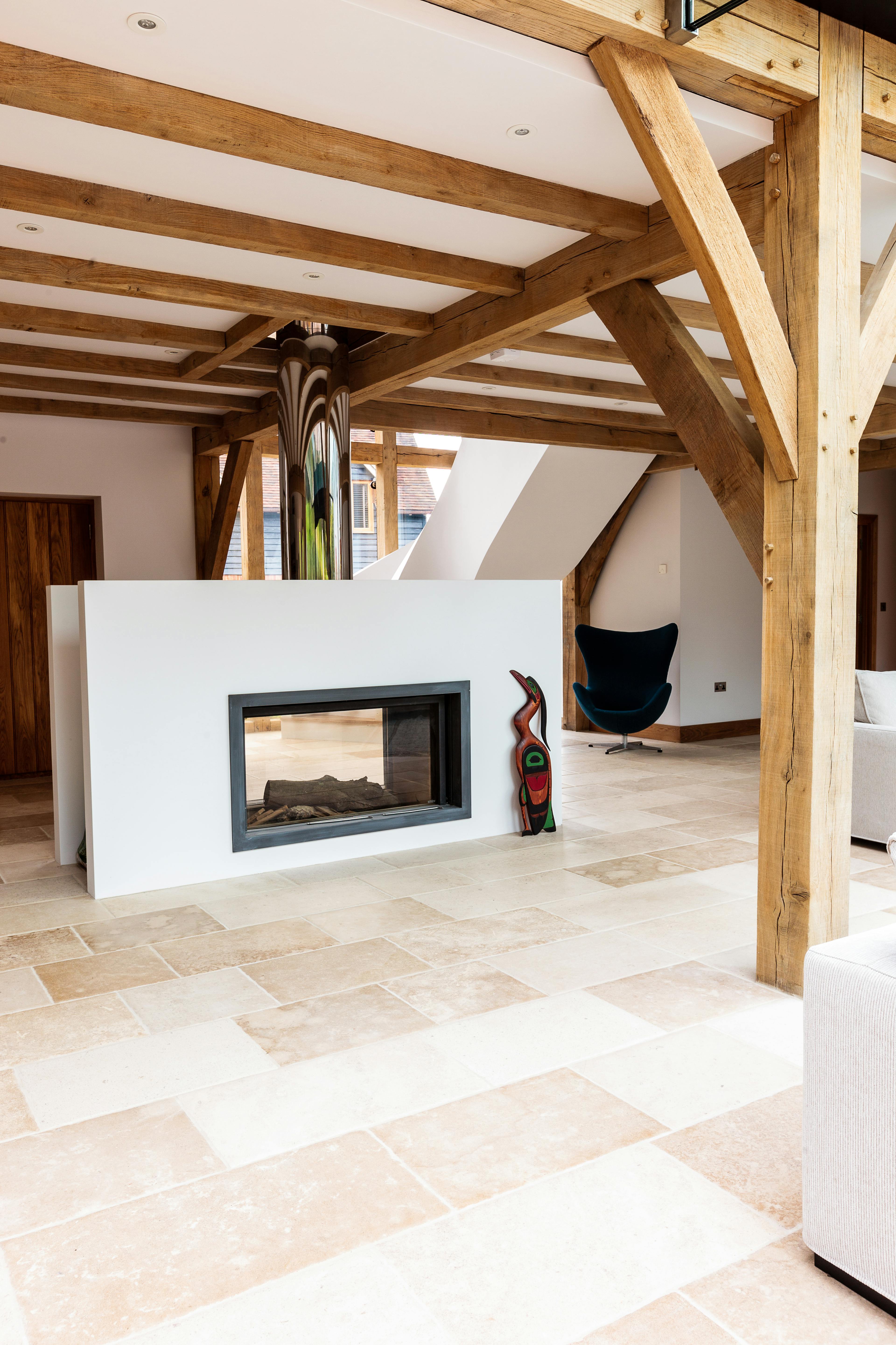 A modern oak framed room with a white fireplace