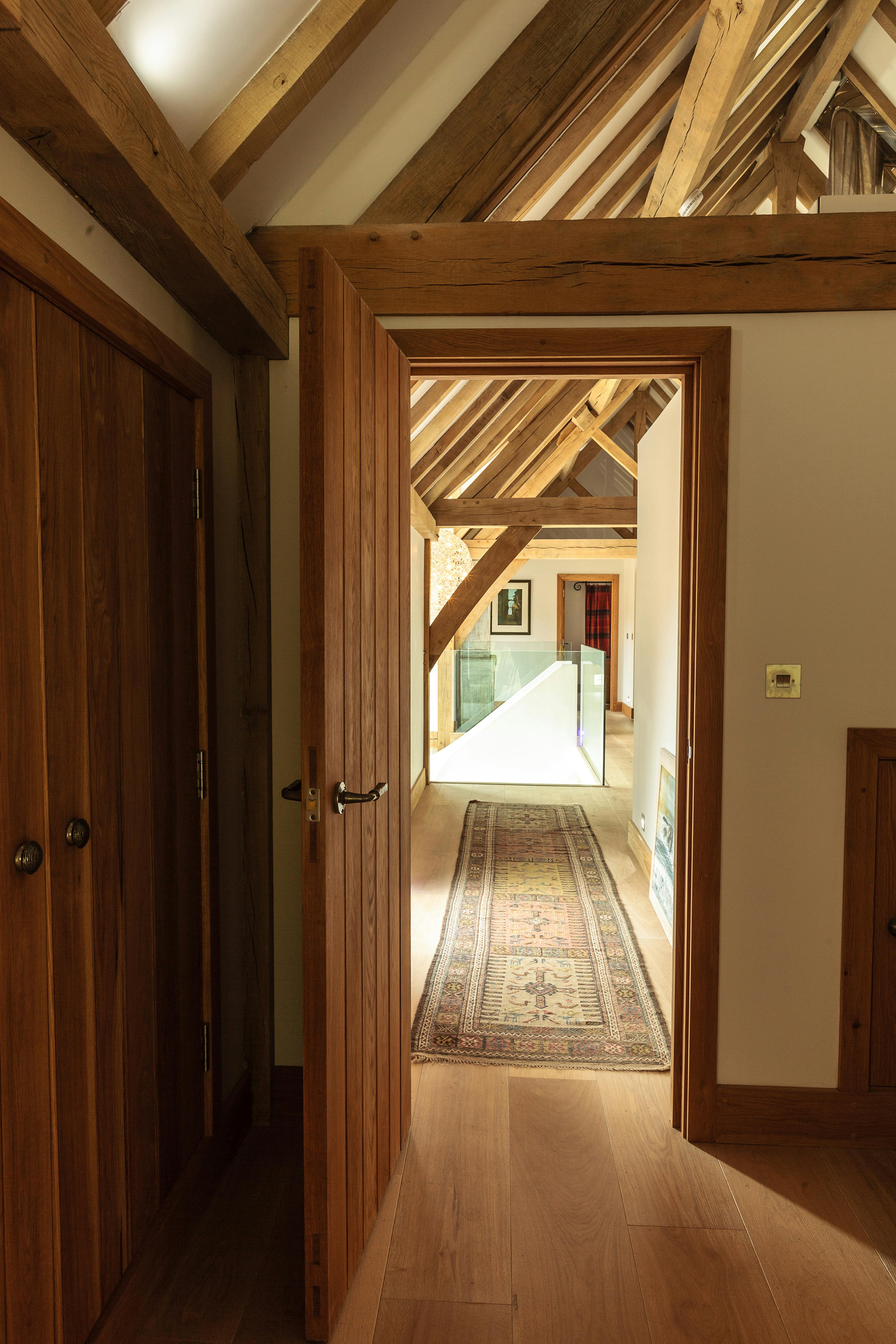 A hallway in an oak framed house with wooden floors