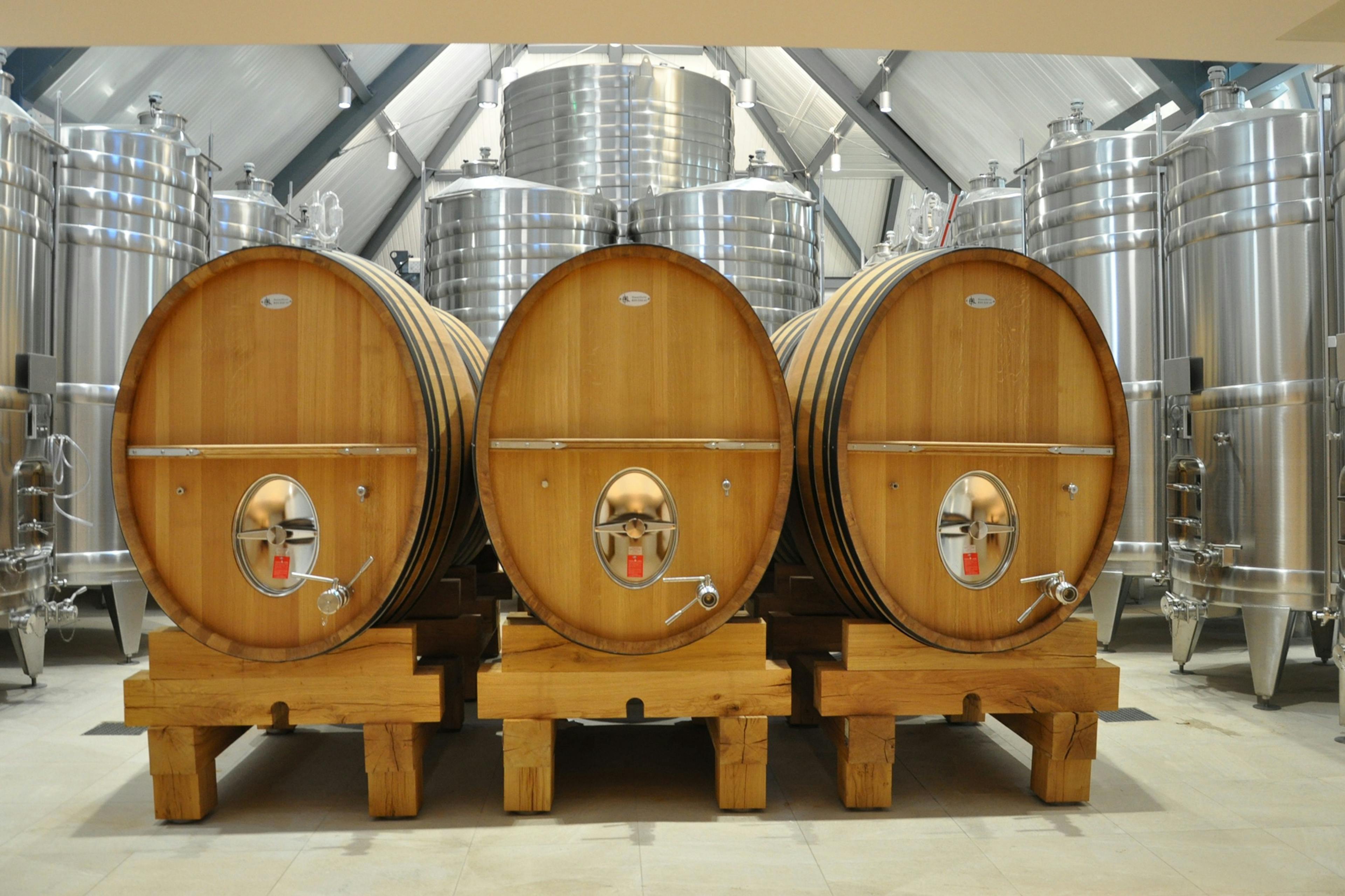 A winery with three large wine barrels