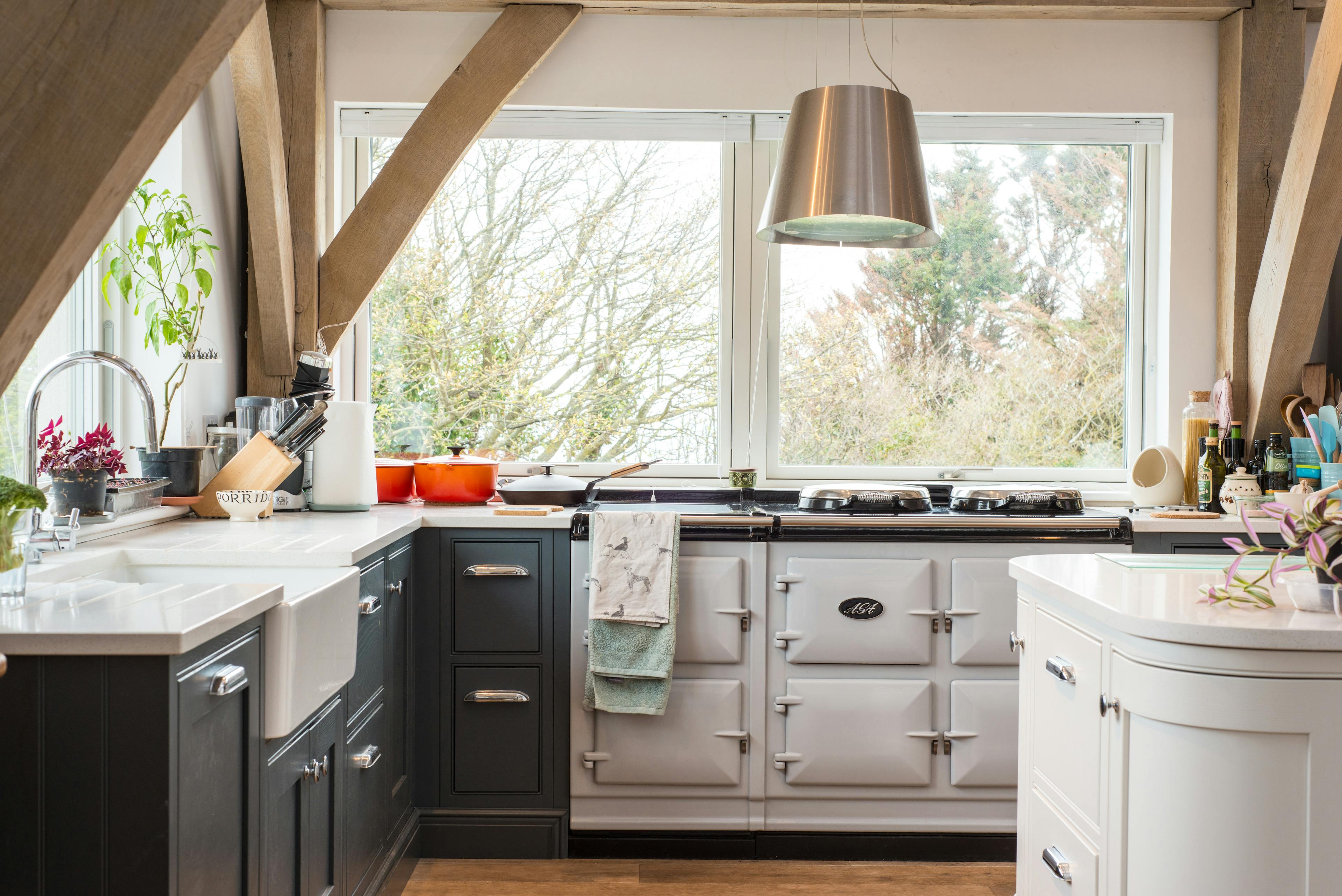 An oak framed kitchen with a white painted island