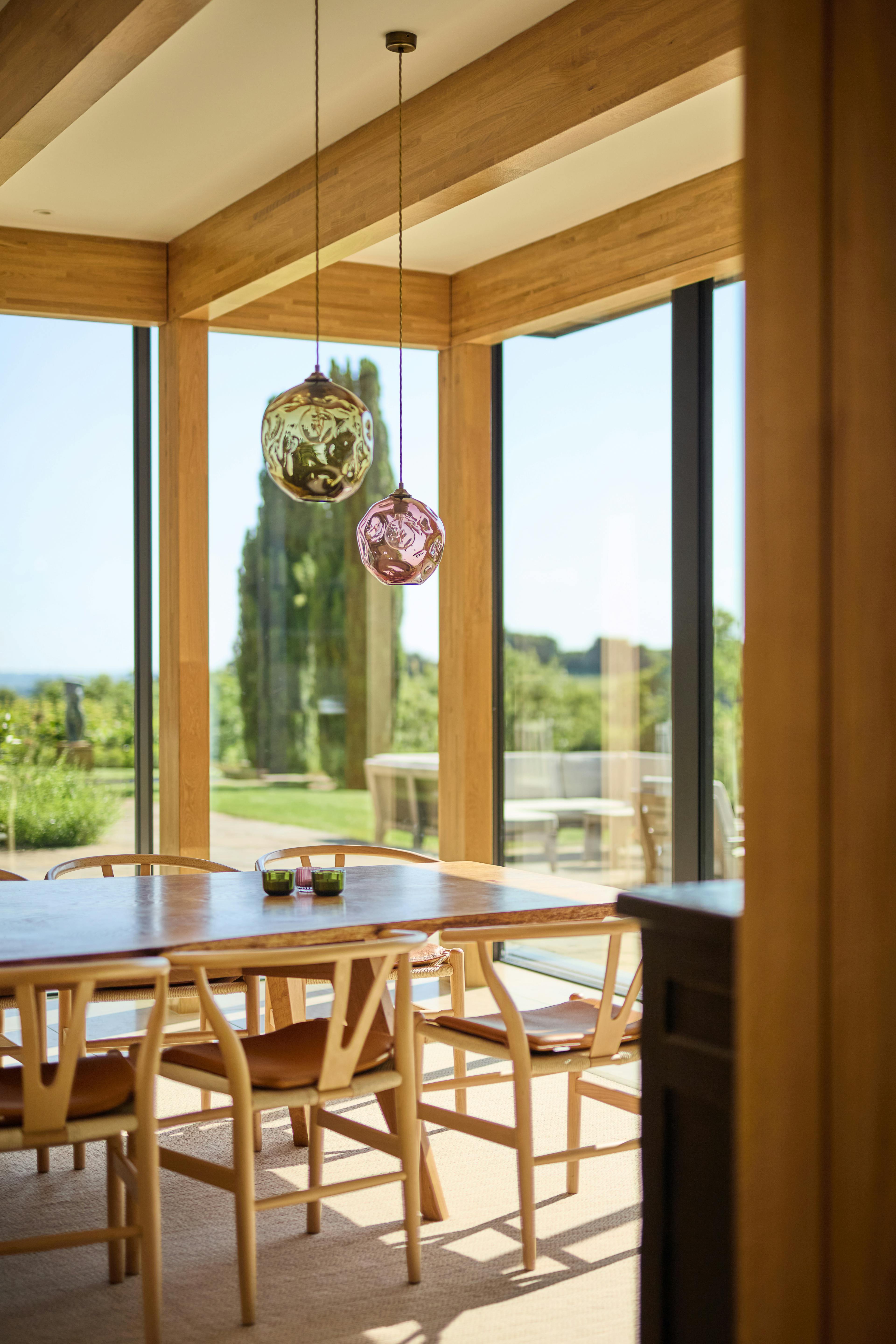 The dining area of an oak glulam extension to a listed manor house